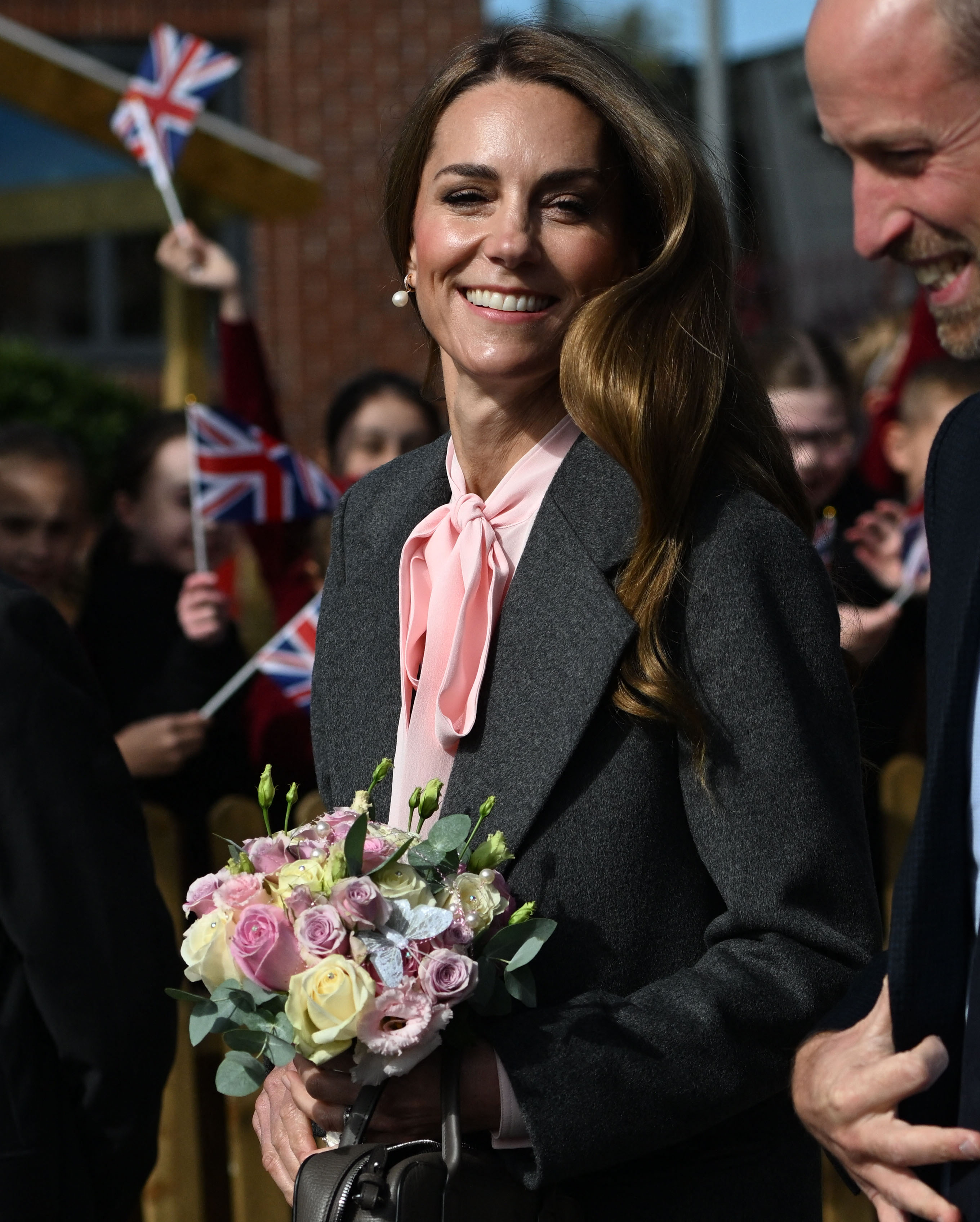 Catherine, Princess of Wales, together with Britain's Prince William, Prince of Wales, smiles during a visit to the Farnborough Road Infant and Junior School during a visit to Southport in north-west England on September 23, 2025. | Source: Getty Images