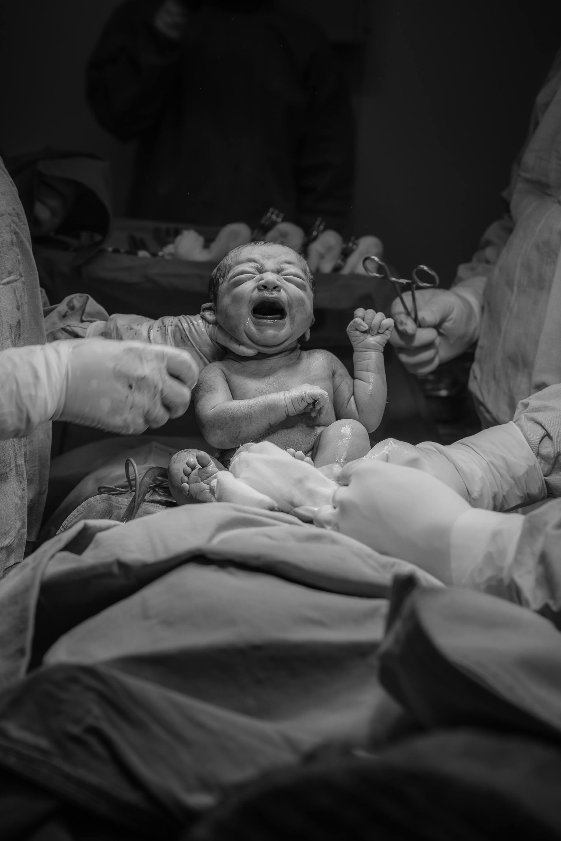 Doctors holding a newborn baby | Source: Pexels
