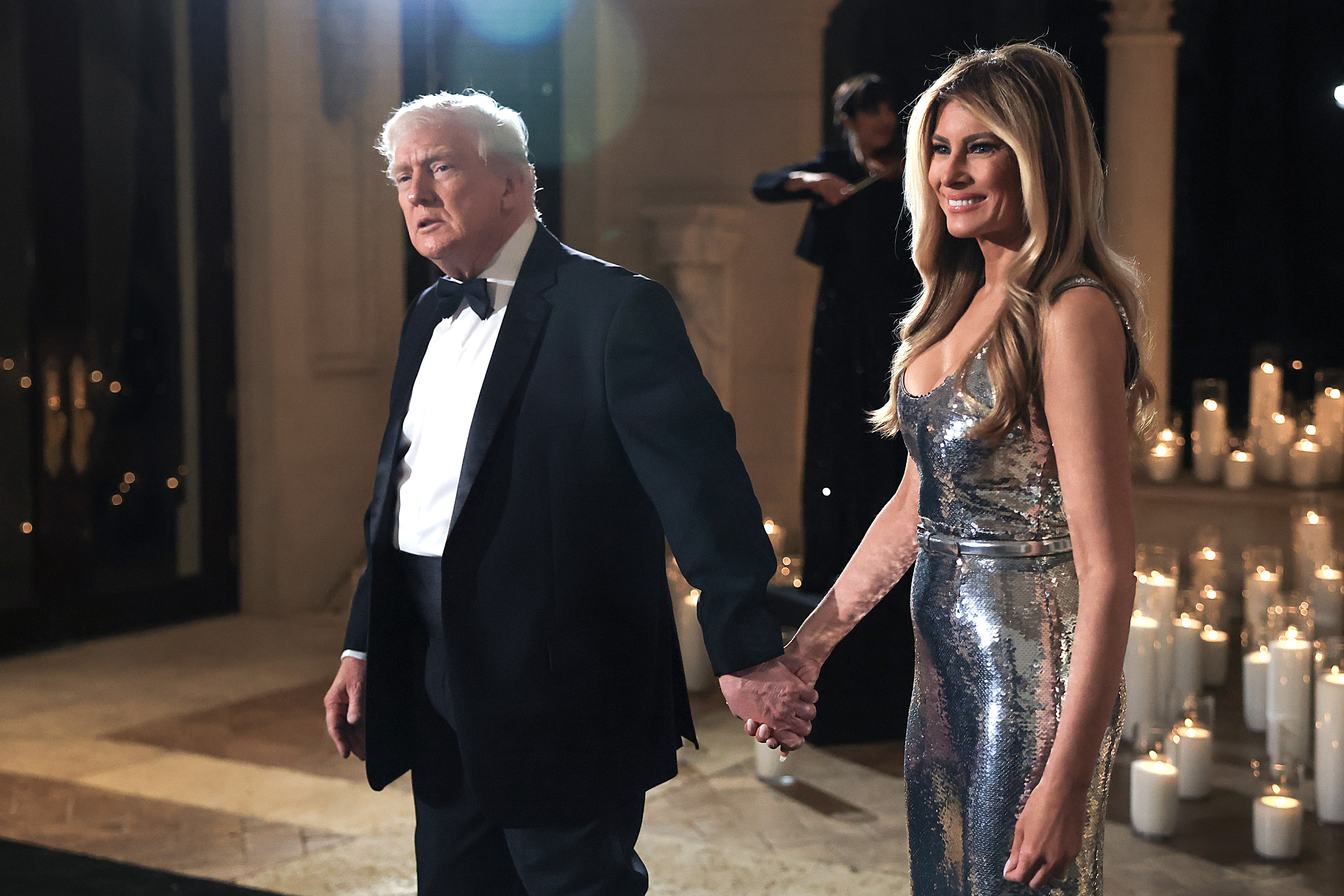 U.S. President Donald Trump and first lady Melania Trump arrive for a New Year’s Eve event at his Mar-a-Lago home on December 31, 2025 in Palm Beach, Florida. | Source: Getty Images