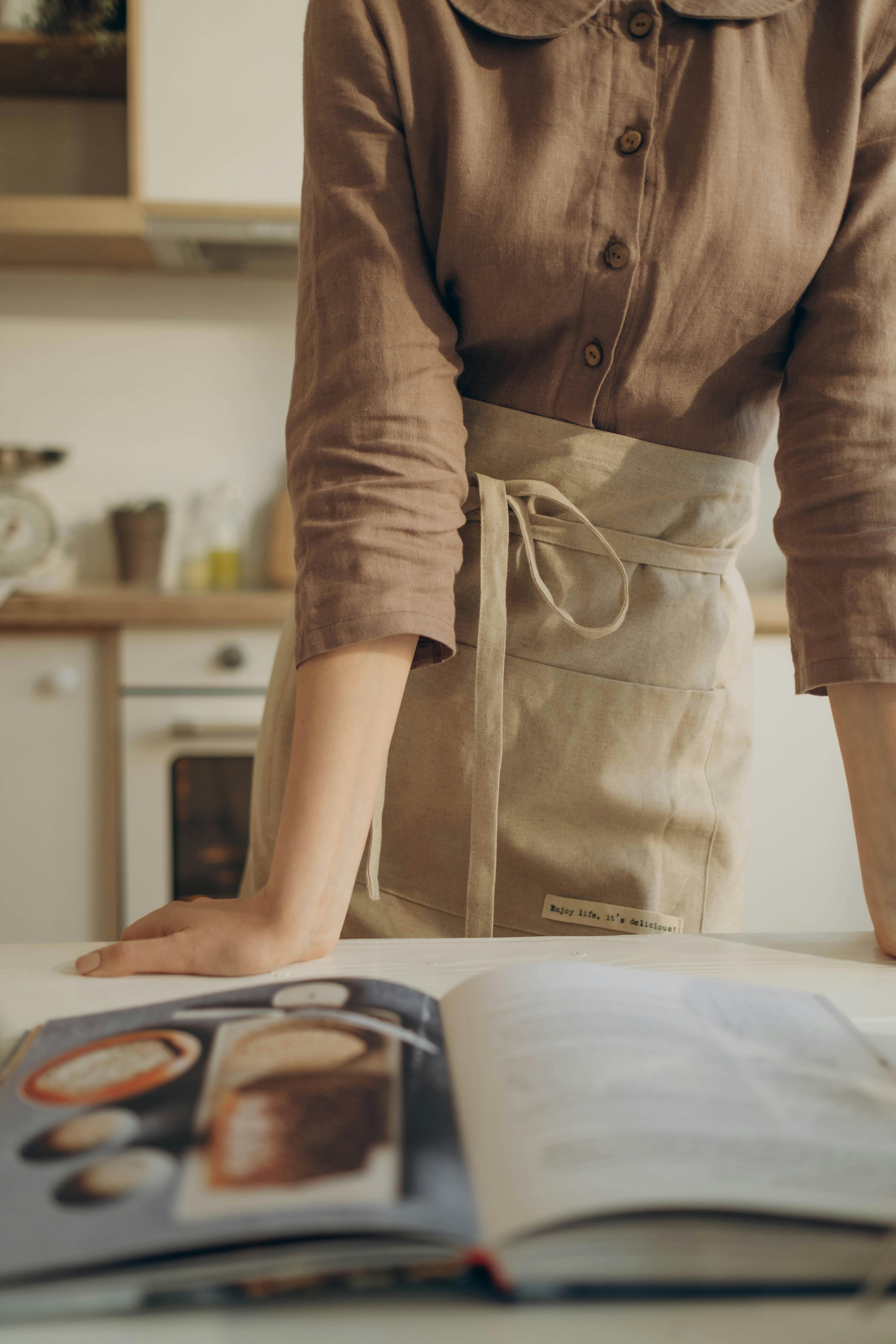 A woman looking at a cookbook | Source: Pexels