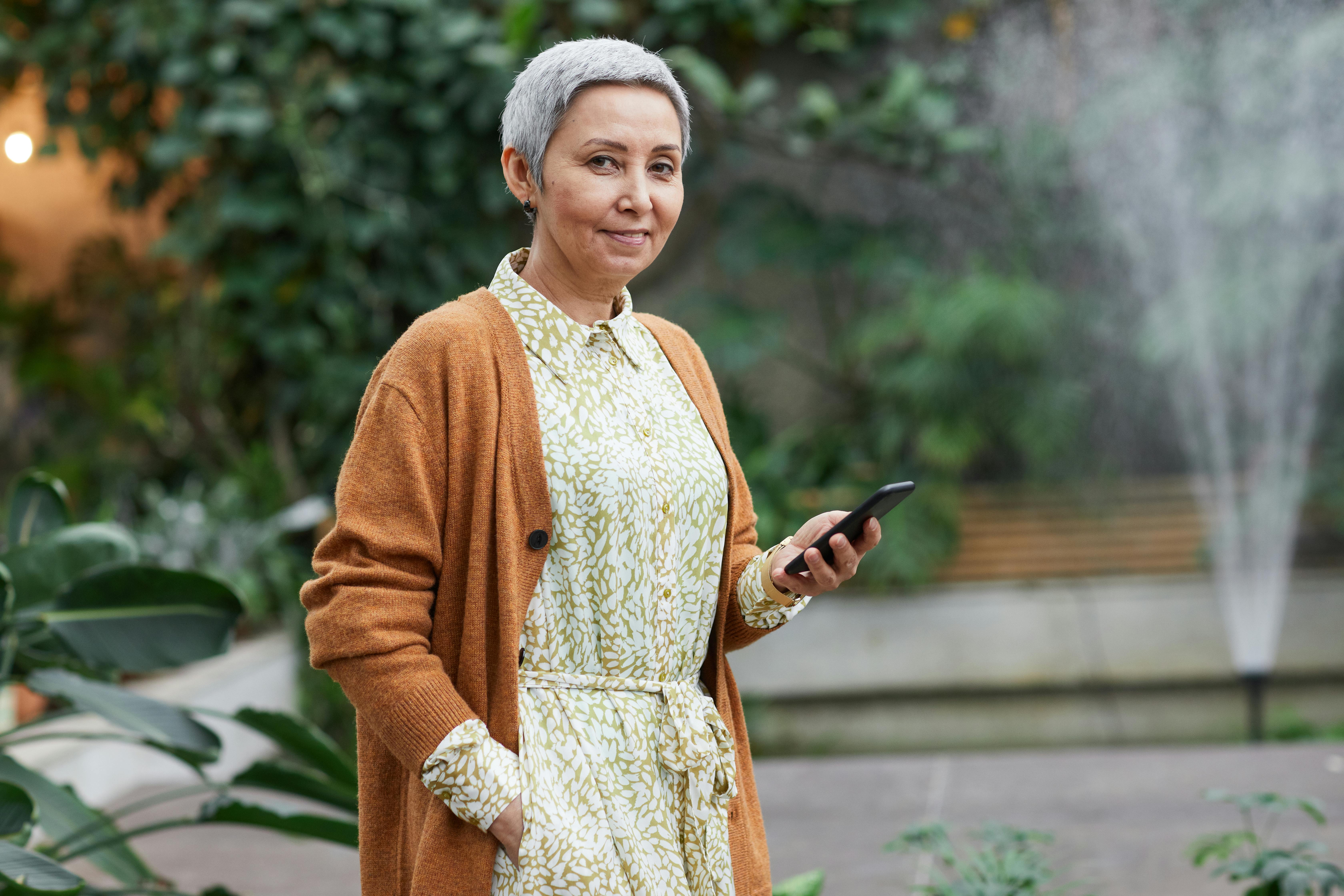 A woman holding a phone | Source: Pexels