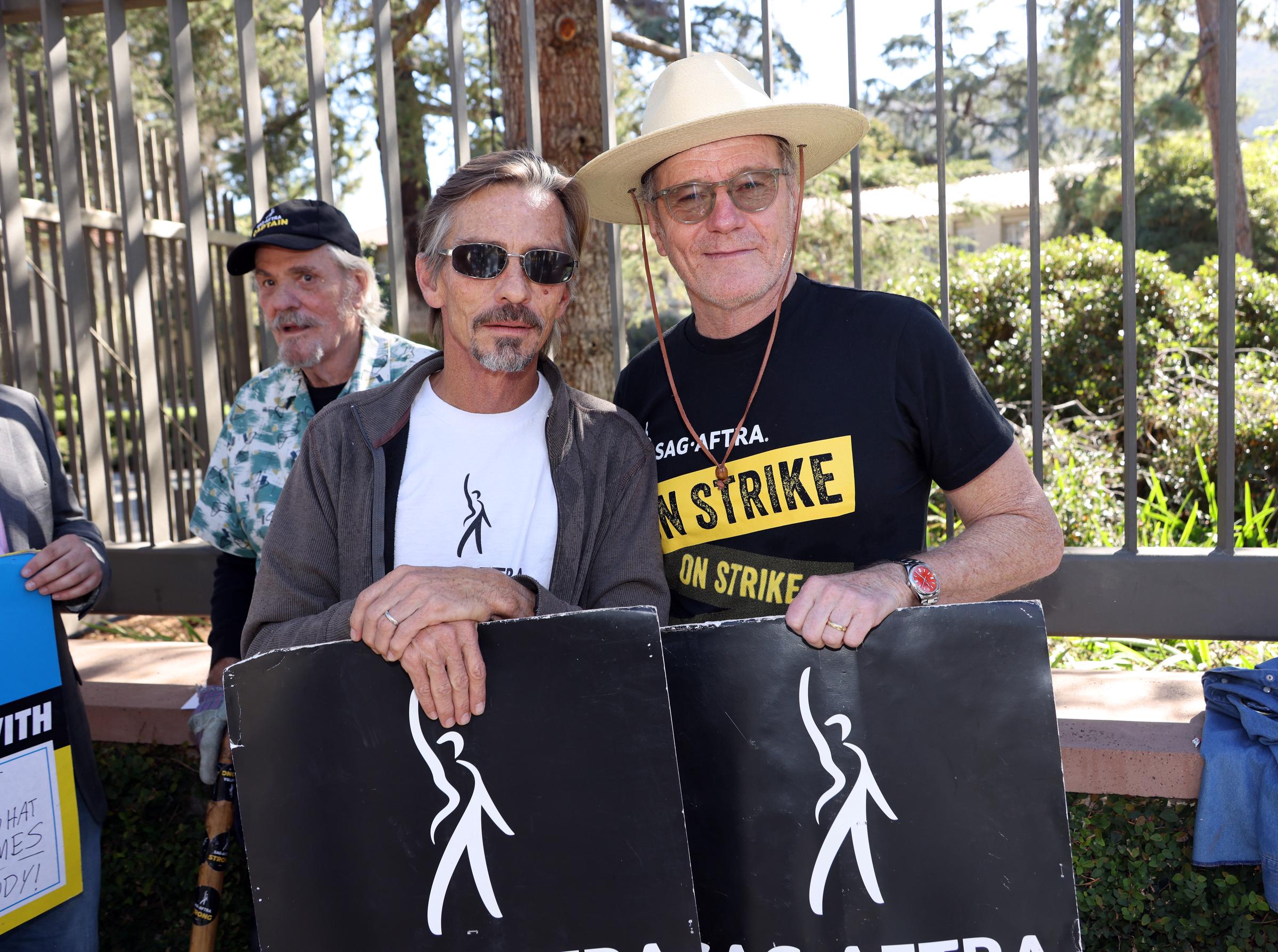 M. C. Gainey, Charles Baker and Bryan Cranston join the picket line outside Warner Bros. Studios on October 31, 2023 in Burbank, California. | Source: Getty Images