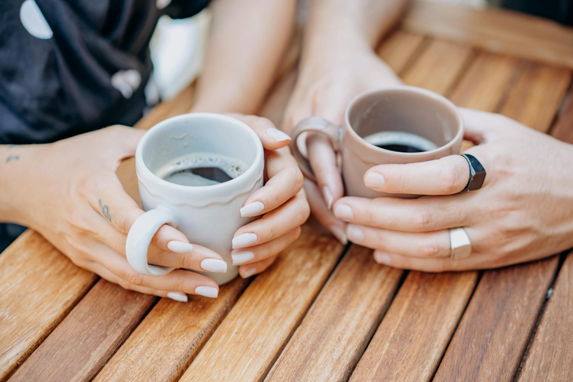 Two women holding coffee cups | Source: Pexels