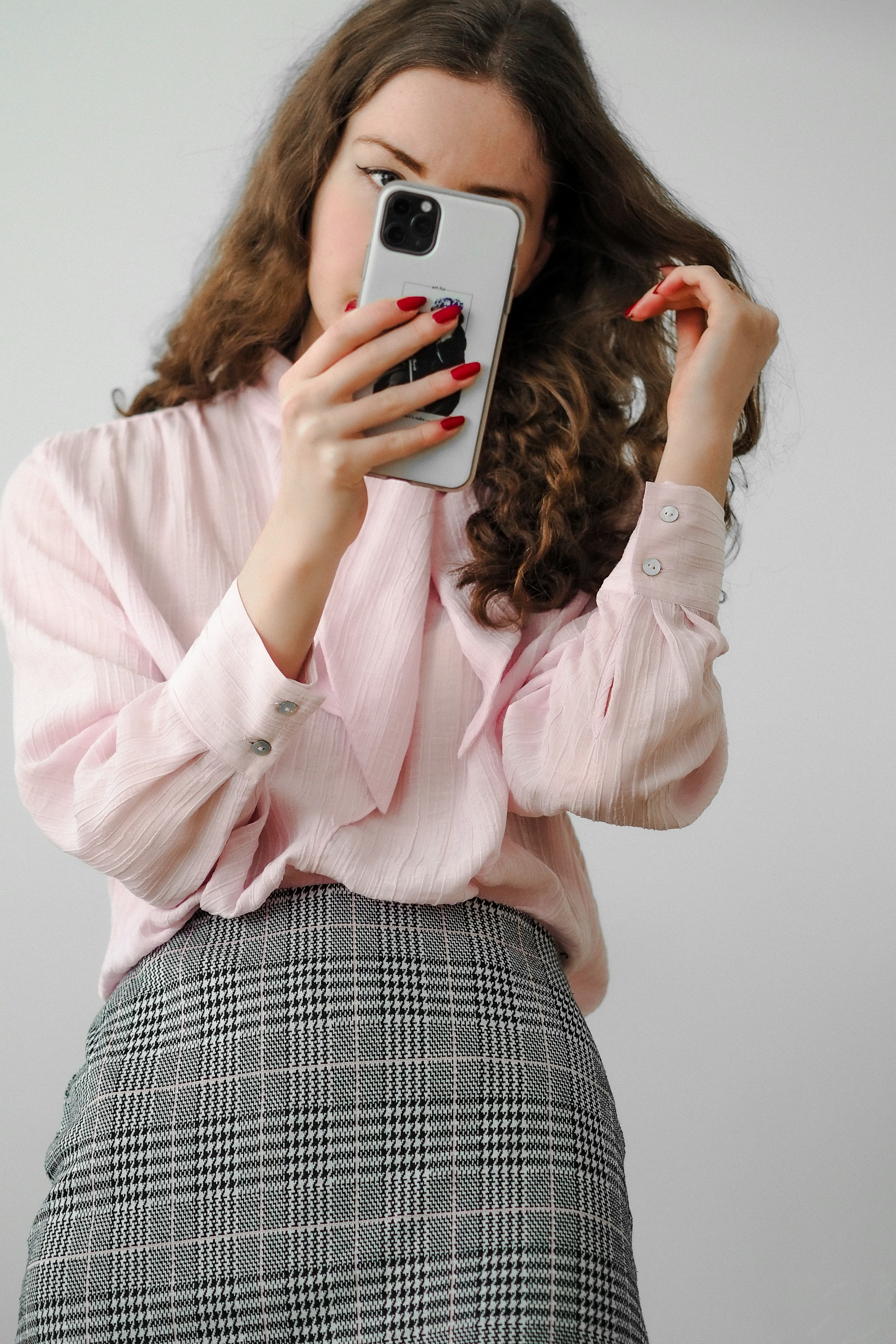 A woman looking at her phone | Source: Unsplash