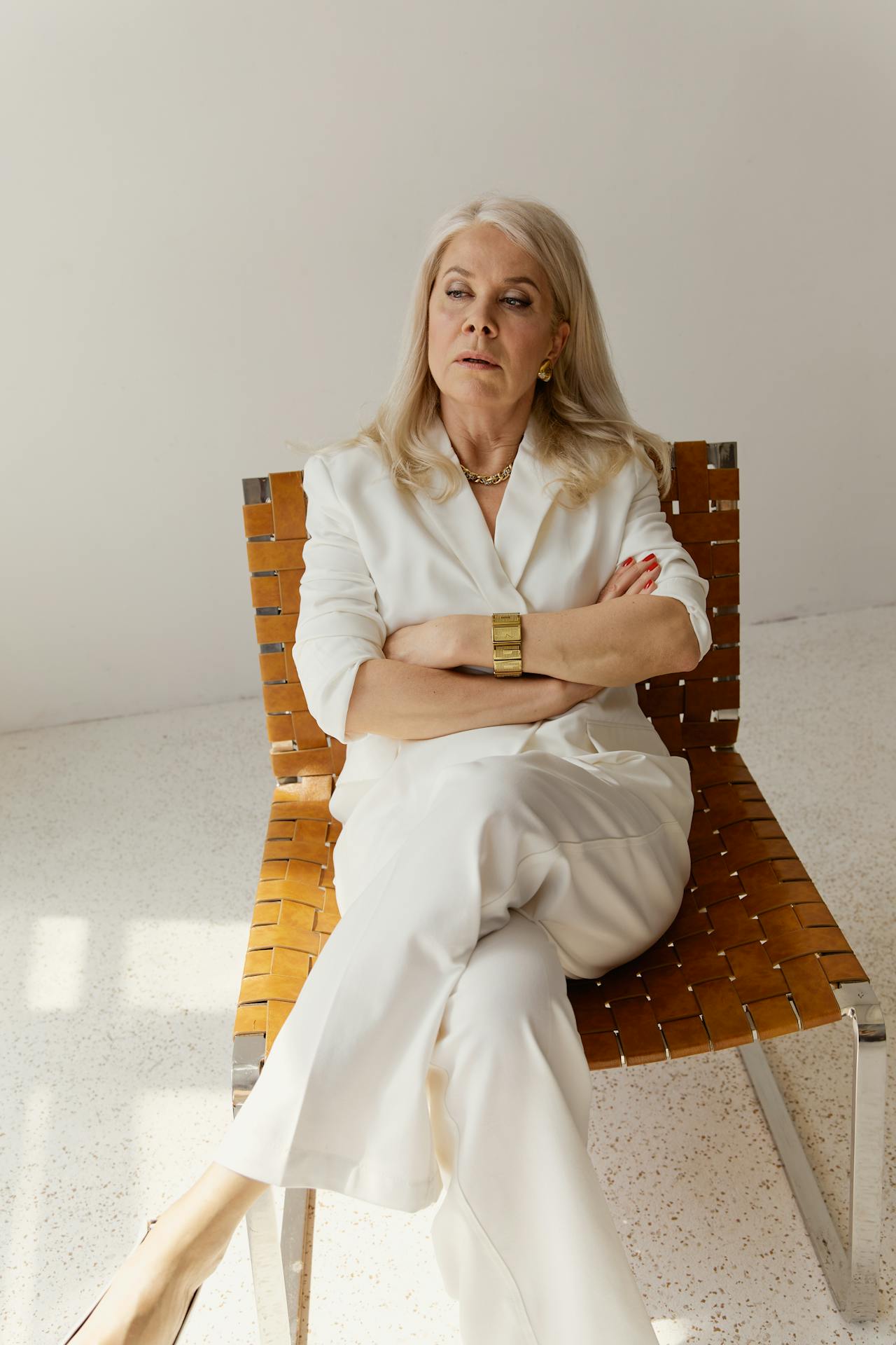 An annoyed older woman sitting on a chair | Source: Pexels