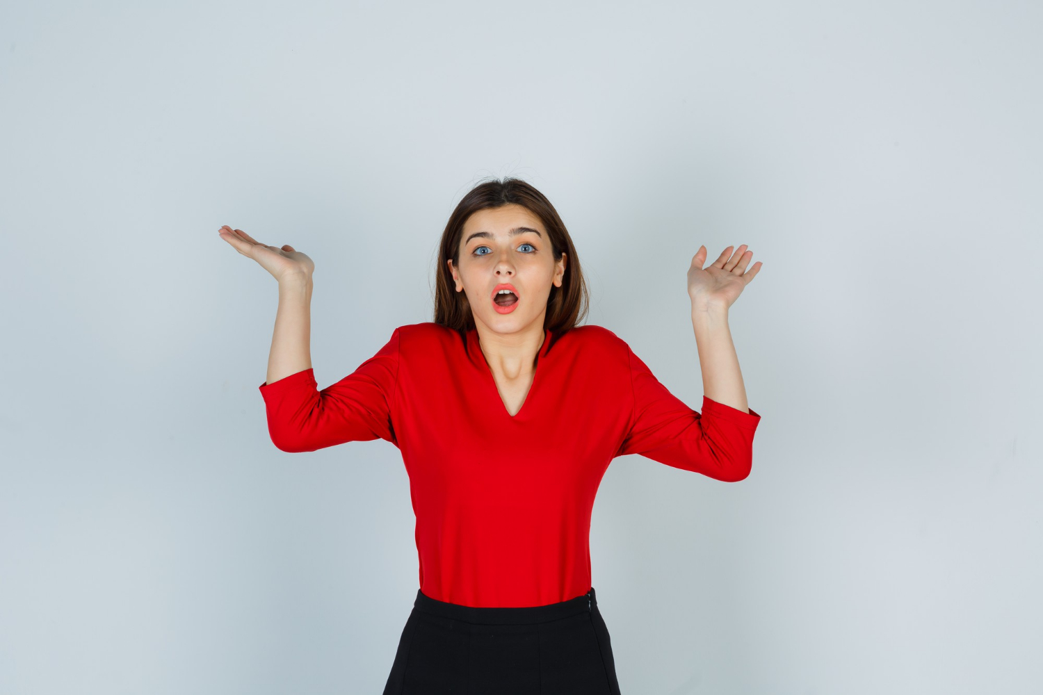 An annoyed woman shrugging | Source: Freepik