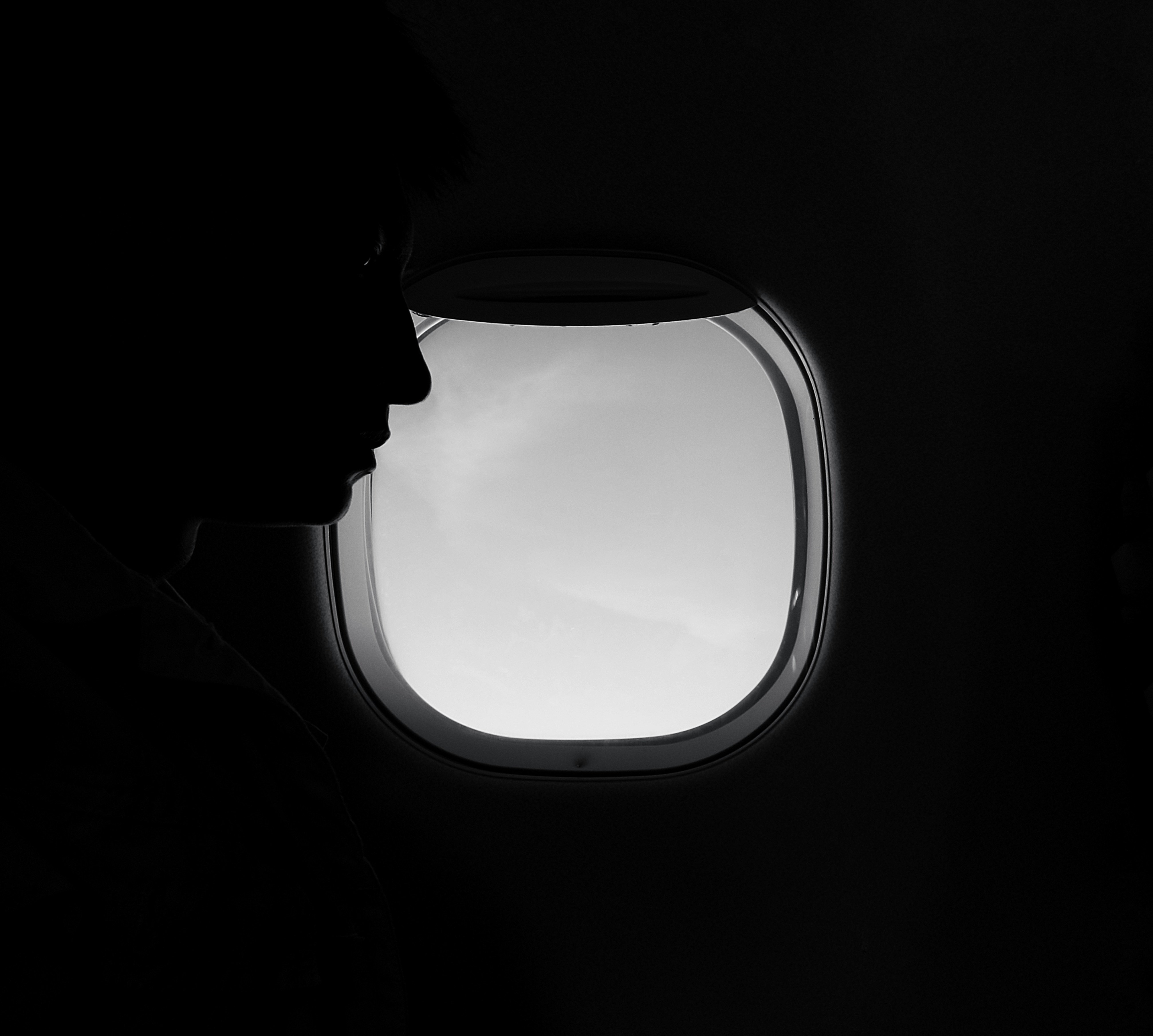 A woman looking at the seat in front of her in an airplane | Source: Unsplash