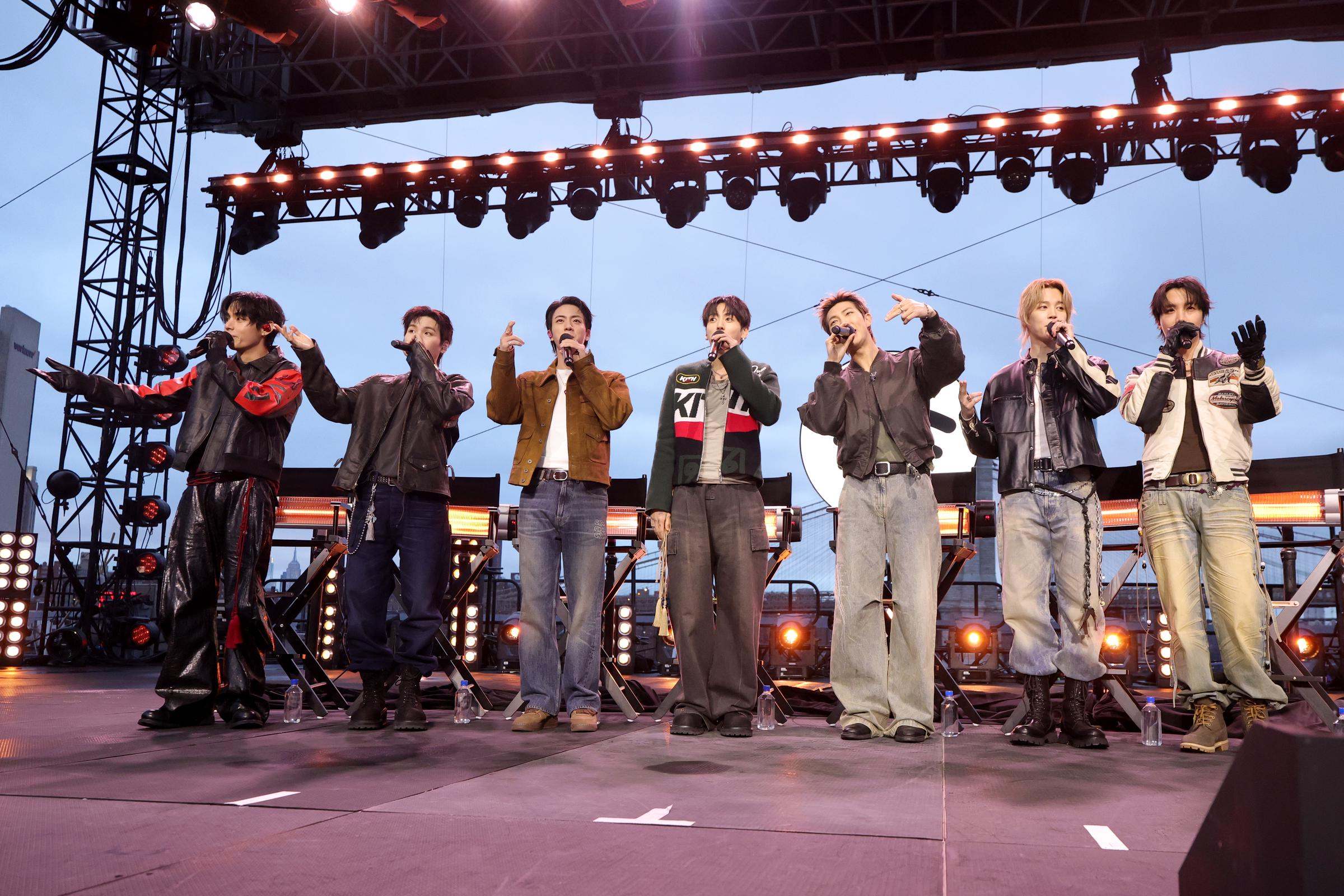 V, Suga, Jin, Jungkook, RM, Jimin and J-Hope of BTS speak onstage during Spotify x BTS: SWIMSIDE at Pier 17 on March 23, 2026 in New York City. | Source: Getty Images