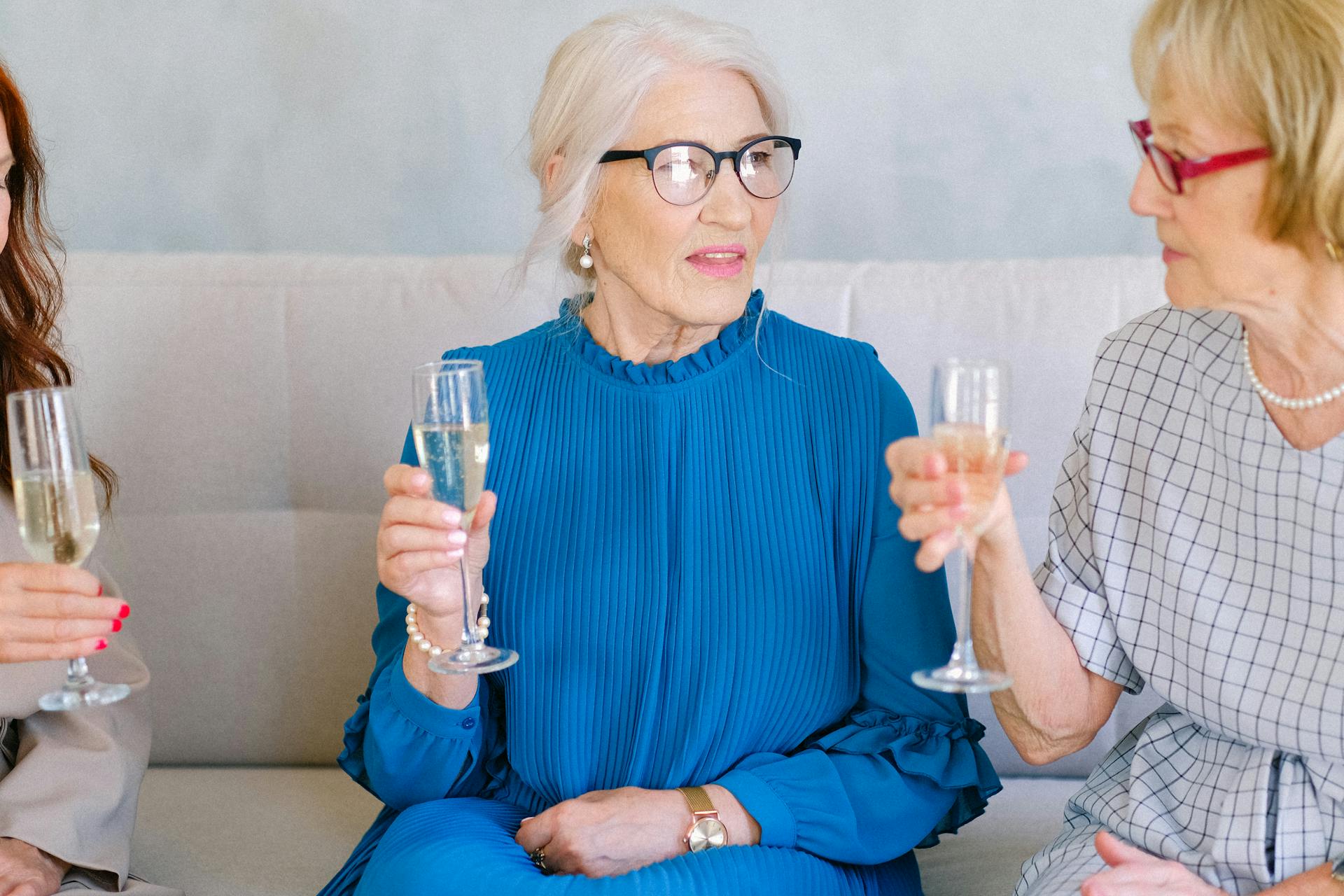 A woman drinking champagne with friends | Source: Pexels