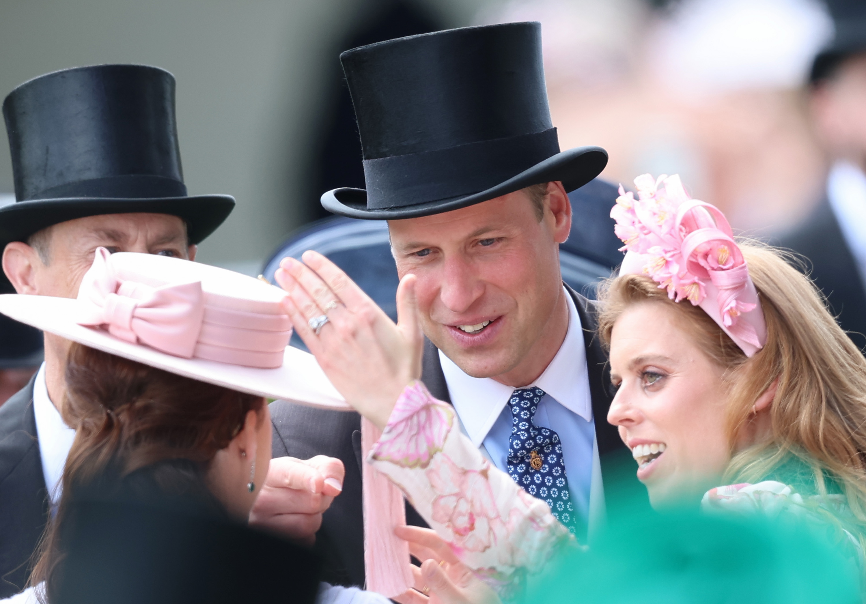 Prince William, Prince of Wales and Princess Beatrice of York laugh as they play with the tassle on Princess Eugenie of York's hat as he attends day two of Royal Ascot 2024 at Ascot Racecourse on June 19, 2024 in Ascot, England. | Source: Getty Images