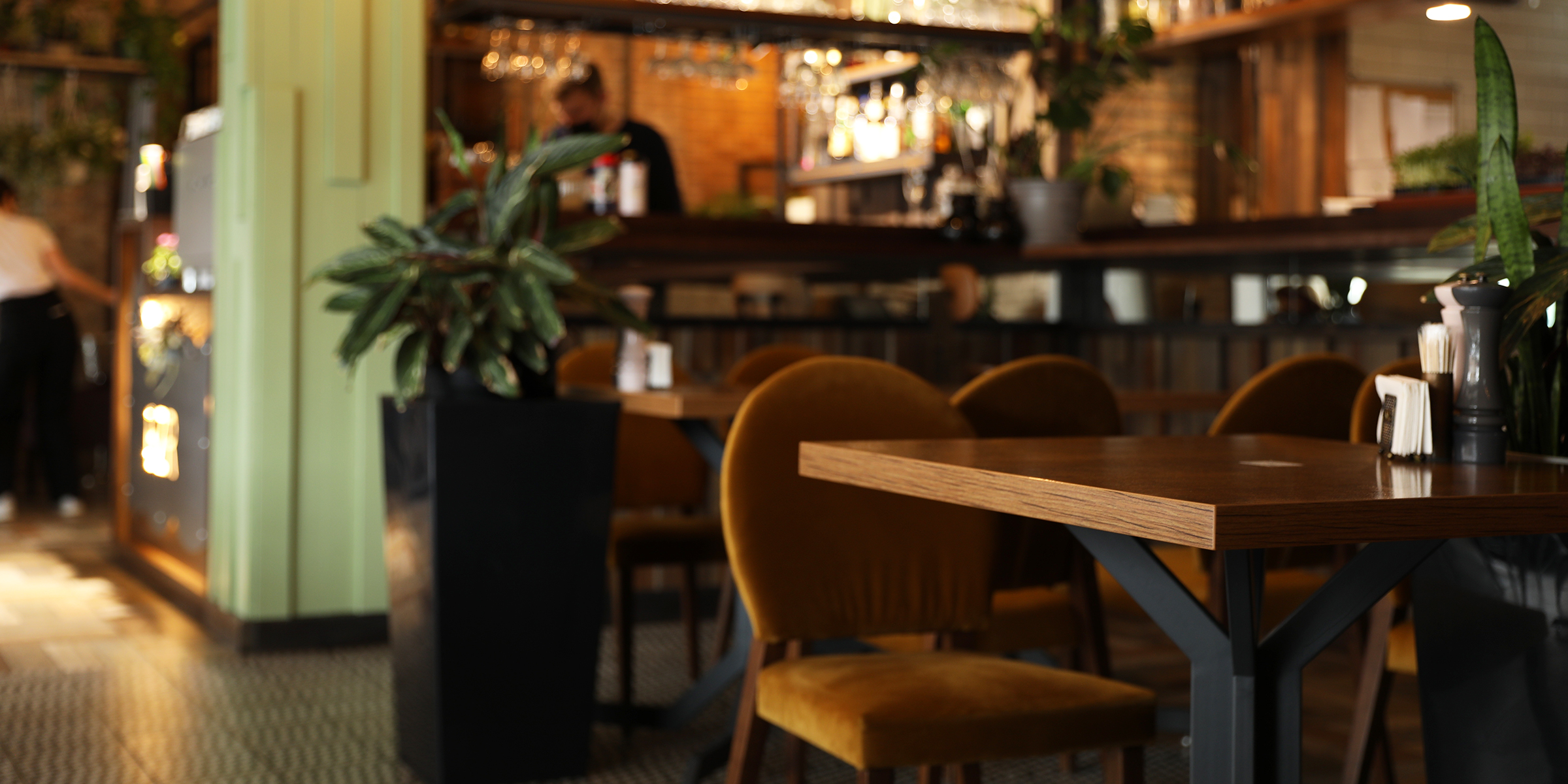 A cozy, modern café with warm lighting, velvet chairs, and a relaxed, inviting vibe | Source: Shutterstock