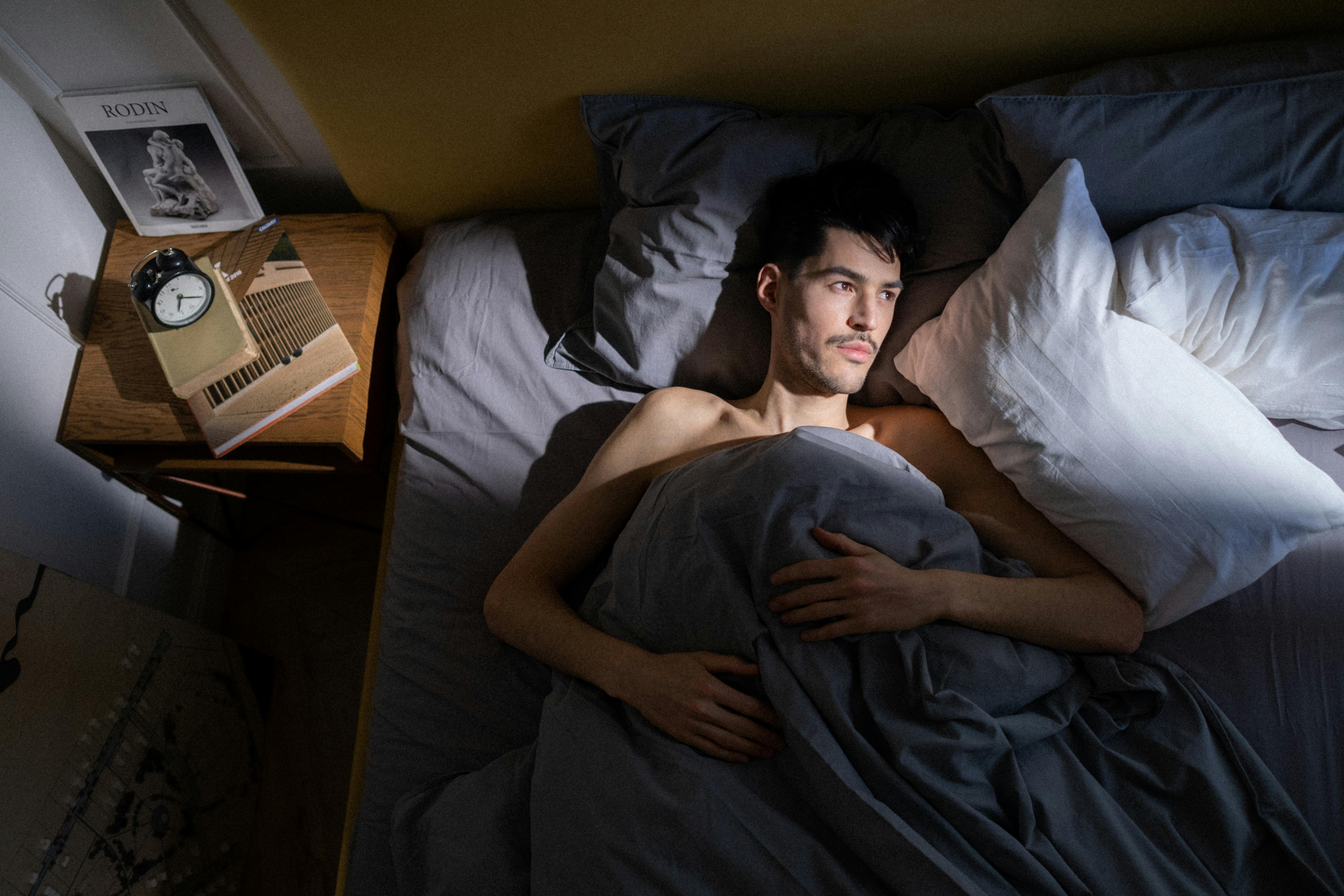 Man laying in bed | Source: Pexels