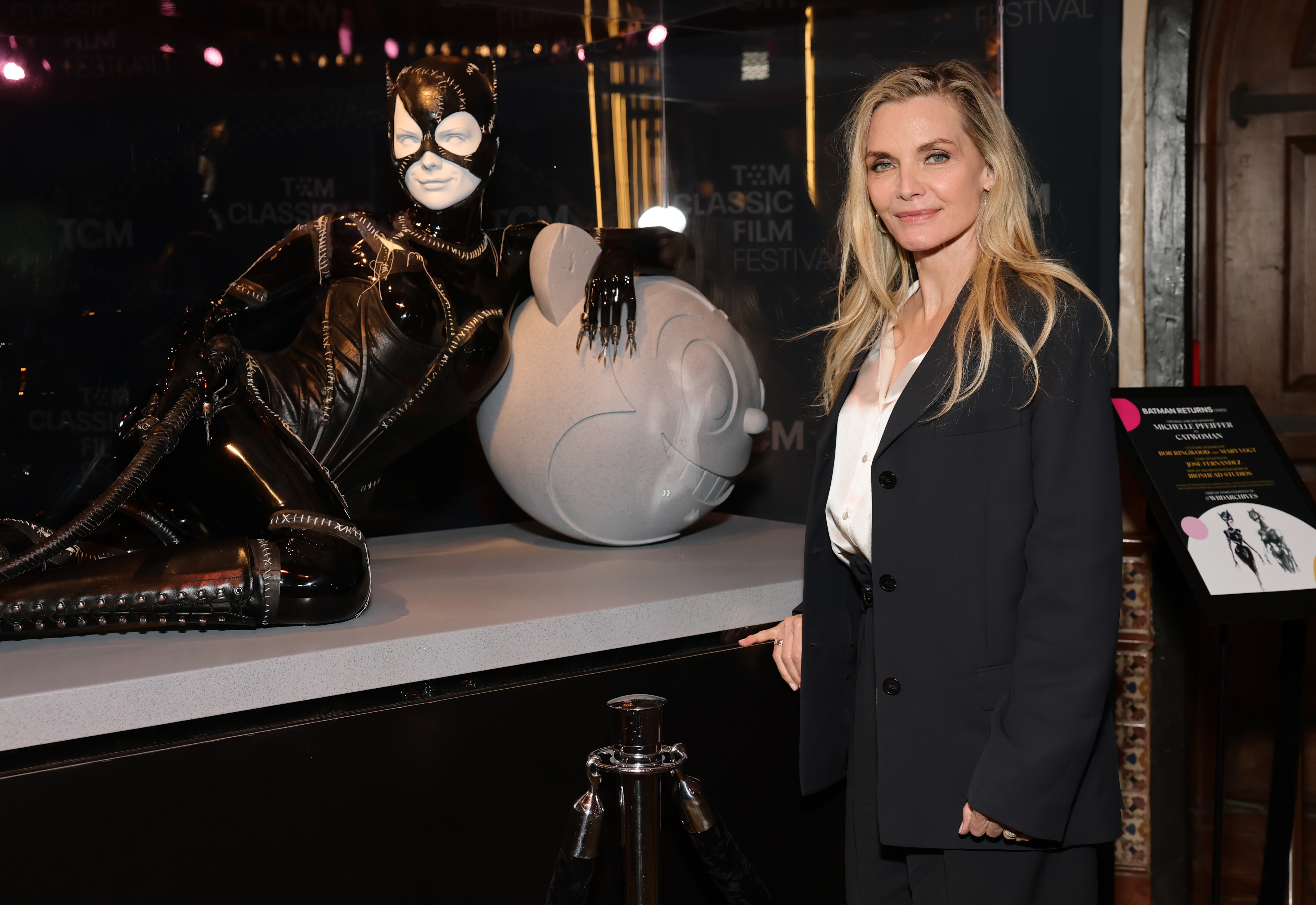 Michelle Pfeiffer poses with the catsuit from "Batman Returns" as TCM honors actress Michelle Pfeiffer with Hand and Footprint Ceremony at TCL Chinese Theatre on April 25, 2025, in Hollywood, California. | Source: Getty Images