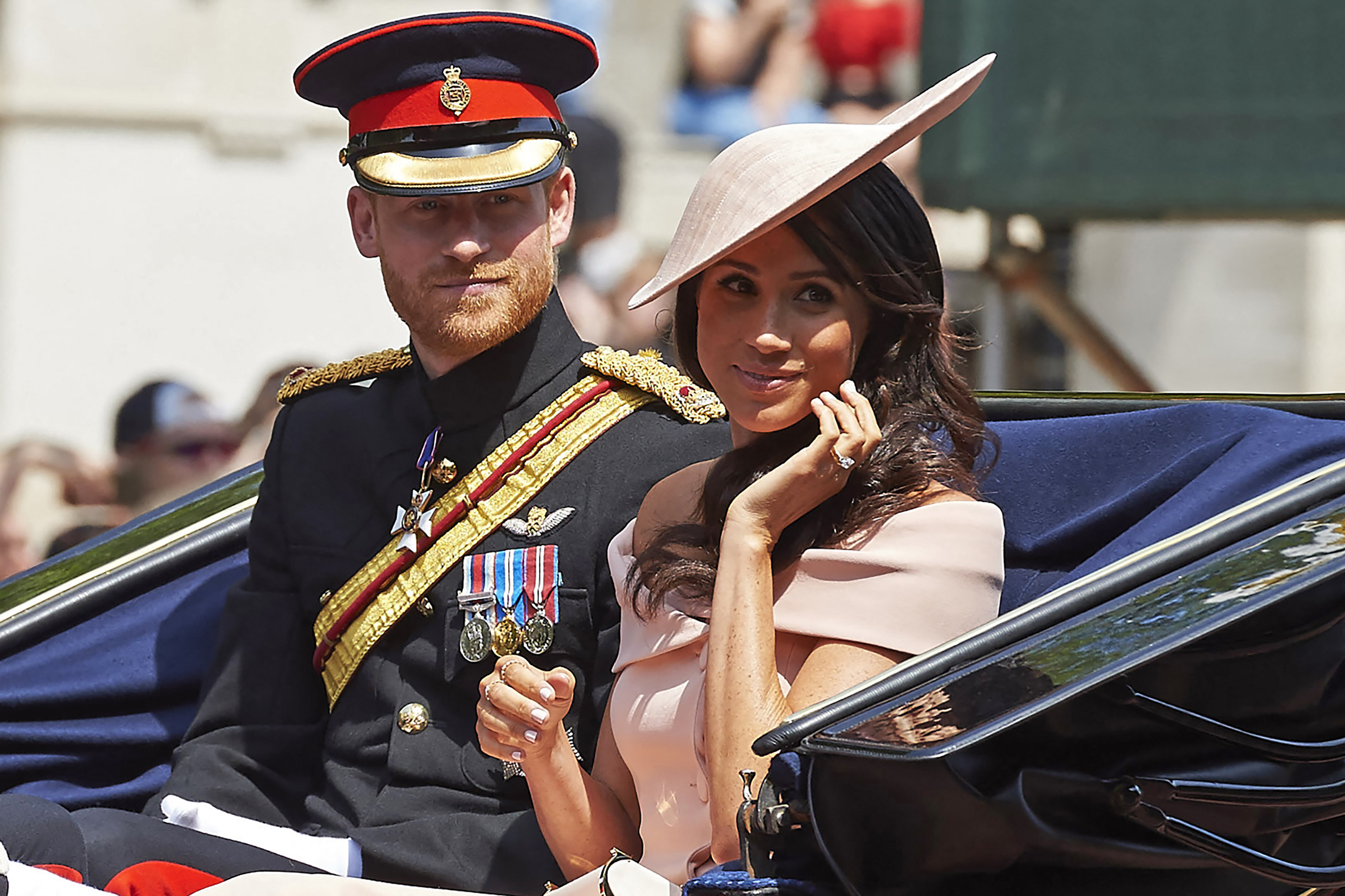 Prince Harry, Duke of Sussex and Meghan, Duchess of Sussex return in a horse-drawn carriage after attending the Queen's Birthday Parade, 'Trooping the Colour,' on Horseguards parade on June 9, 2018, in London. | Source: Getty Images