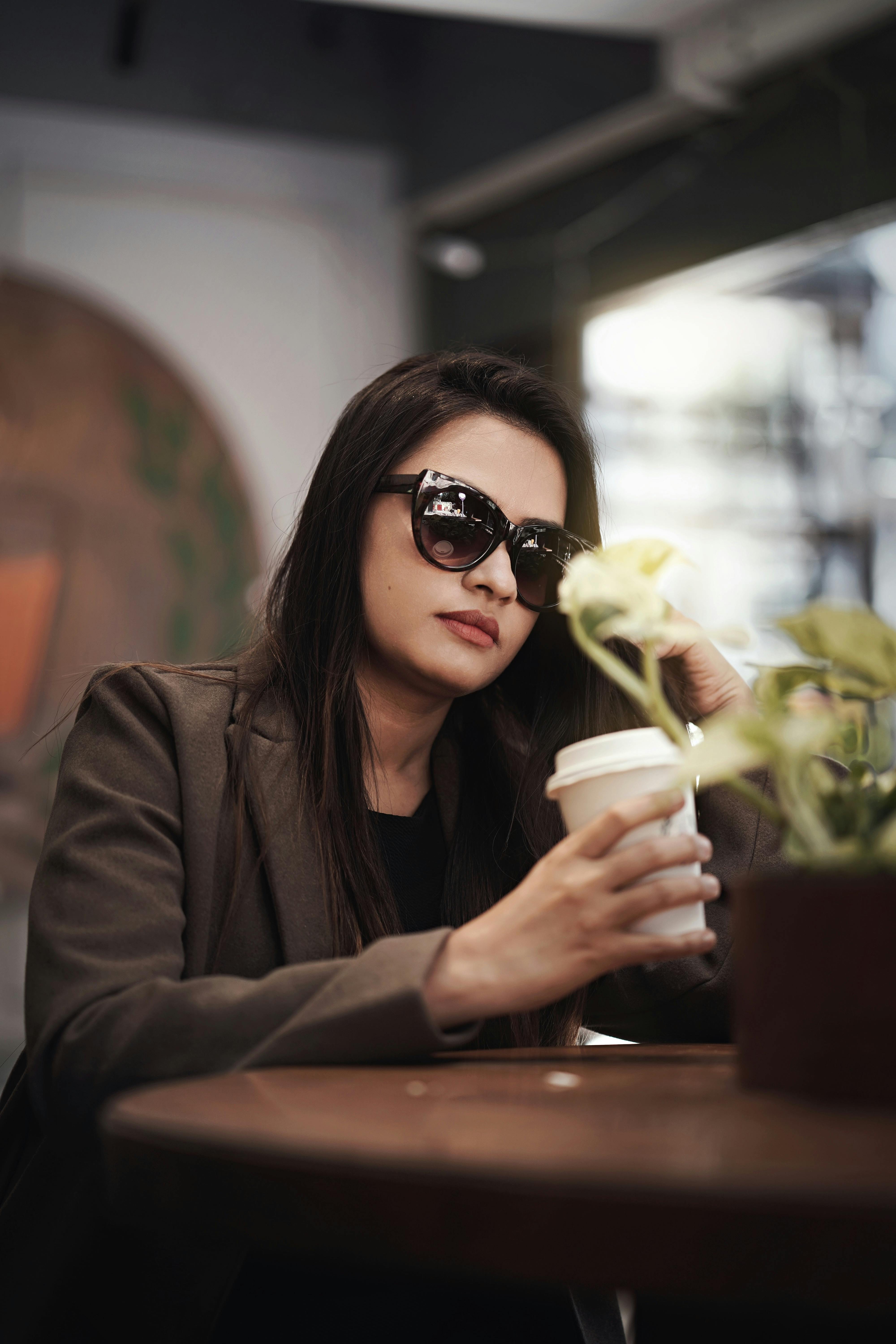Woman holding a cup of coffee | Source: Pexels