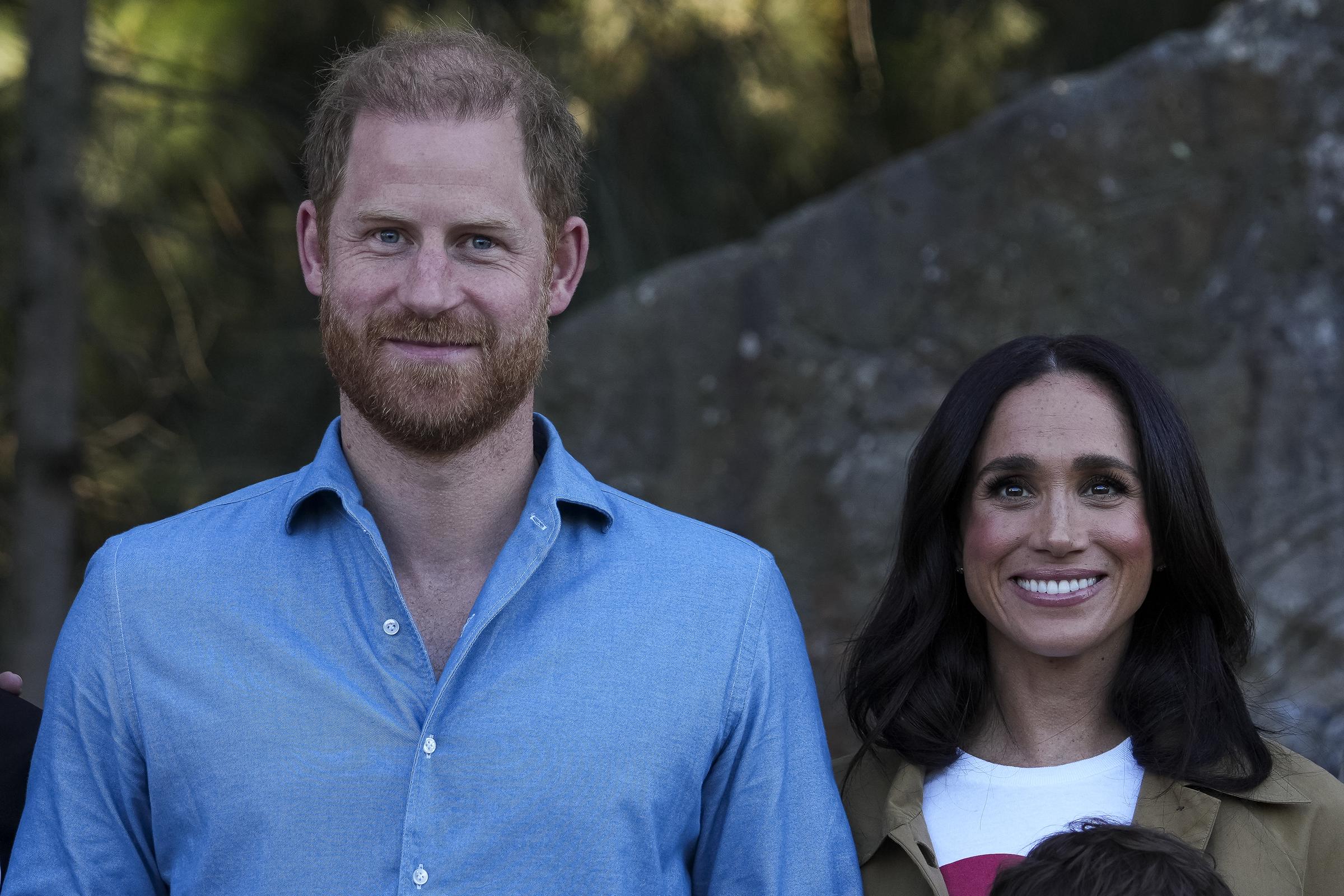Prince Harry, Duke of Sussex and Meghan, Duchess of Sussex pose for a photo during a Scar Tree Walk on April 16, 2026 in Melbourne, Australia. | Source: Getty Images