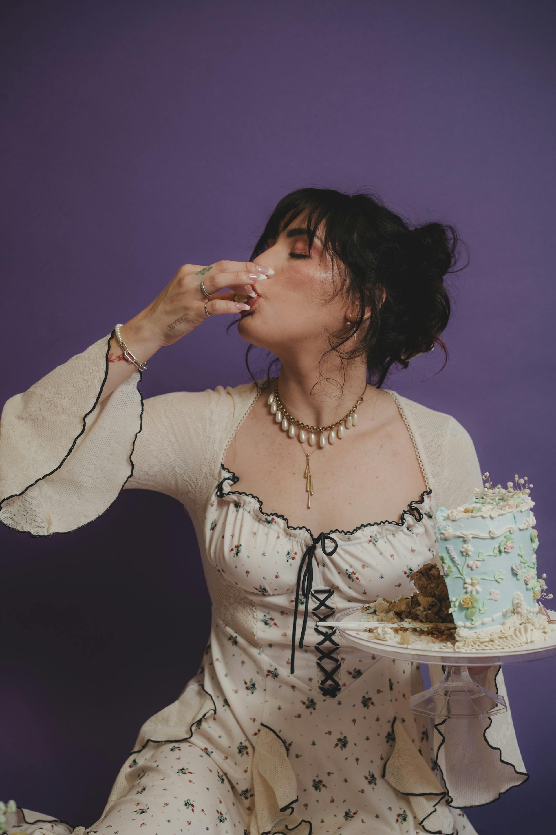 A woman enjoying a slice of birthday cake | Source: Pexels