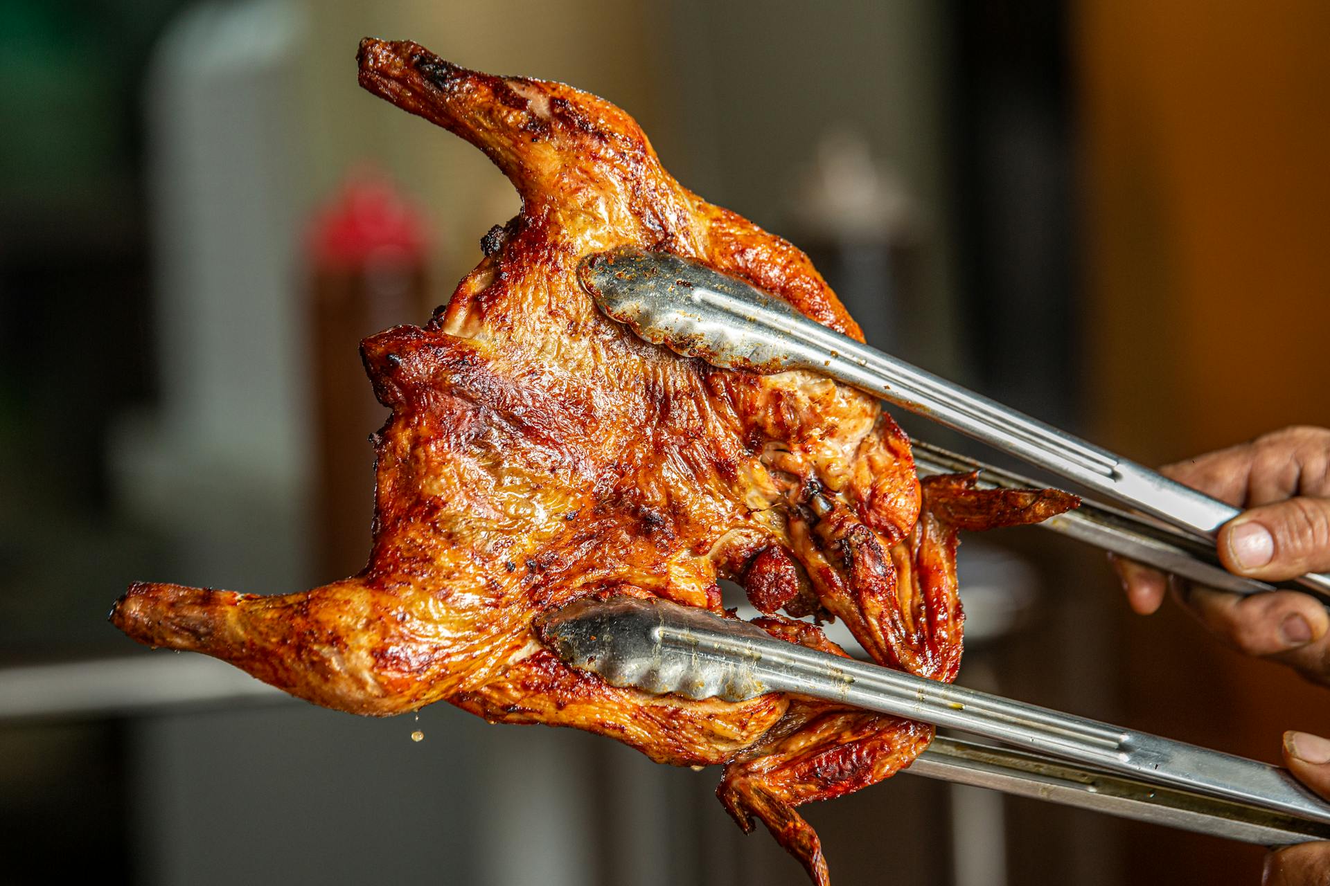A person holding a roasted chicken | Source: Pexels