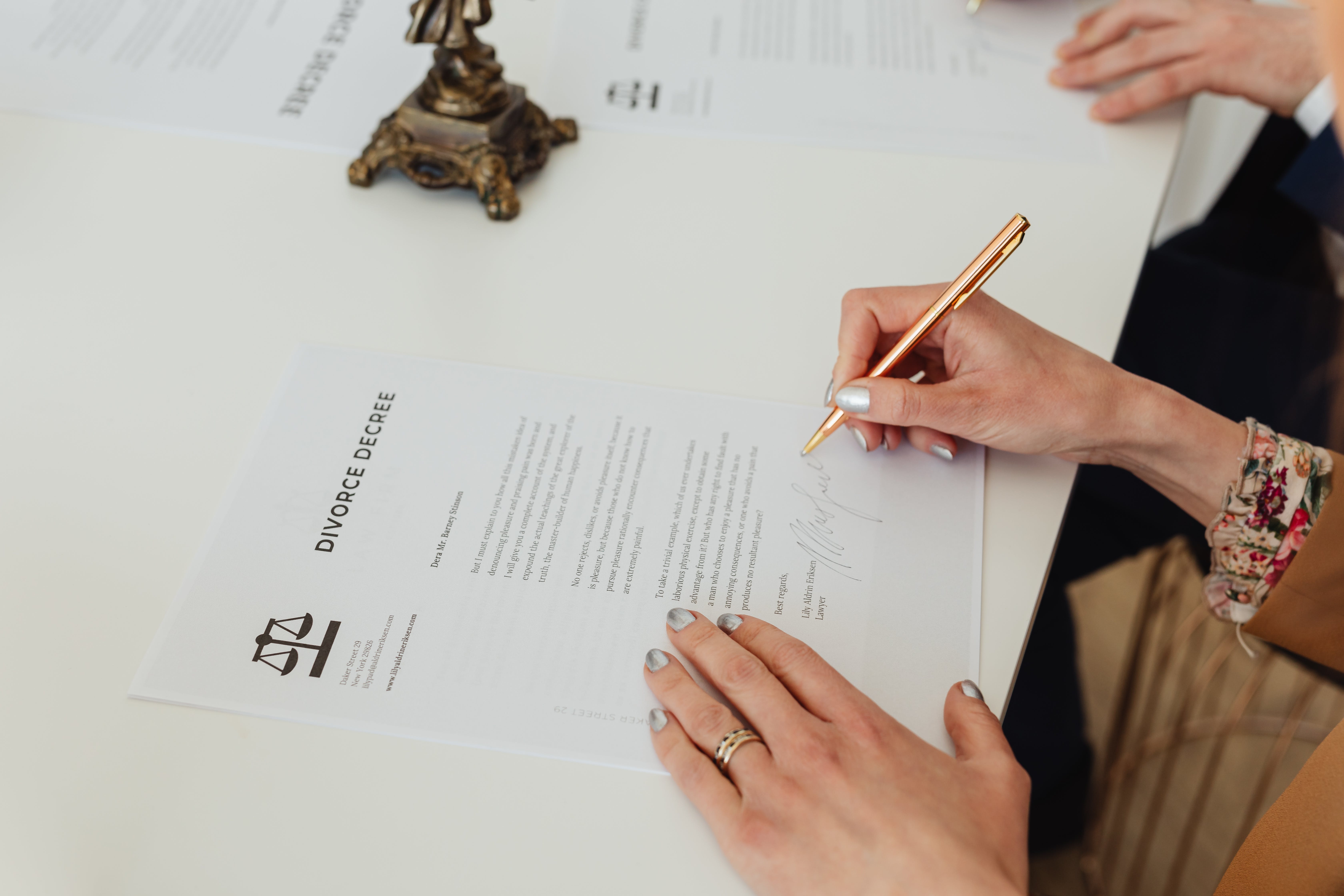 Divorce paperwork being signed | Source: Pexels