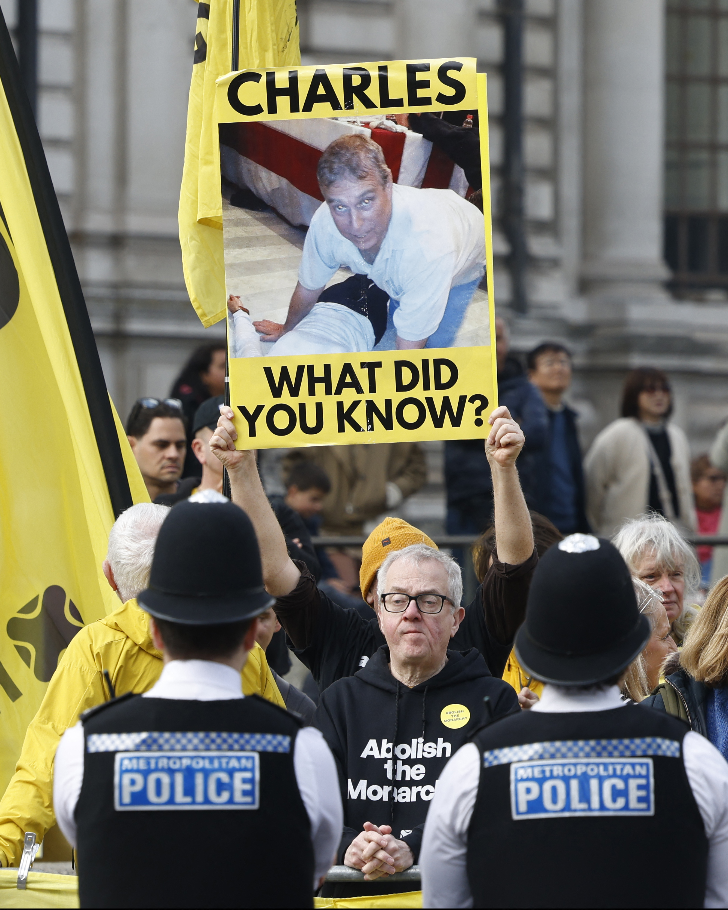 Protestors hold placards and wave flags outside the annual Commonwealth Day service ceremony at Westminster Abbey in London, on March 9, 2026. | Source: Getty Images