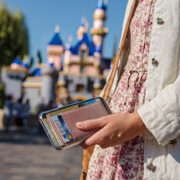 A woman holds her phone, passport, ID, and cards | Source: Midjourney