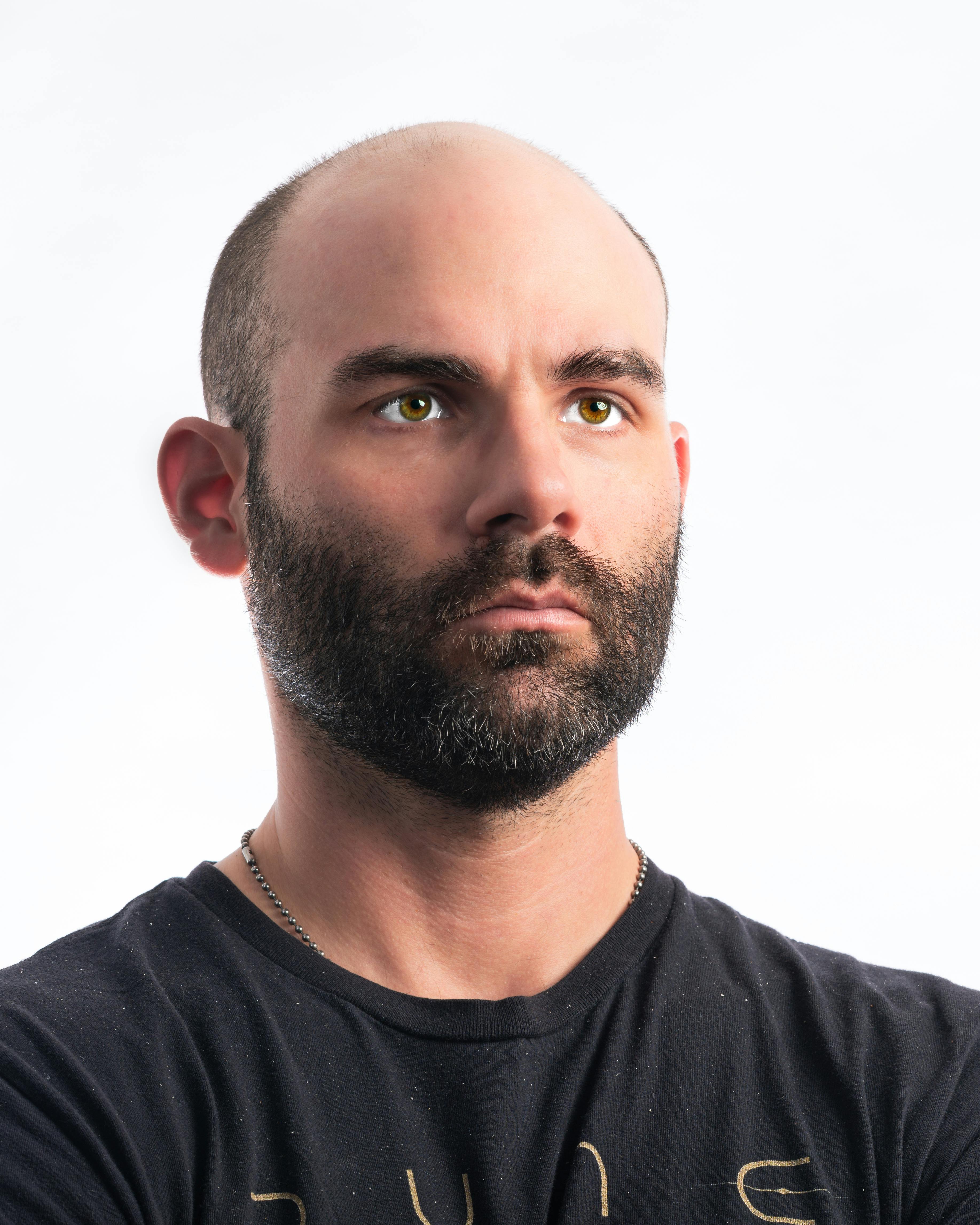A stern man wearing a black t-shirt | Source: Pexels