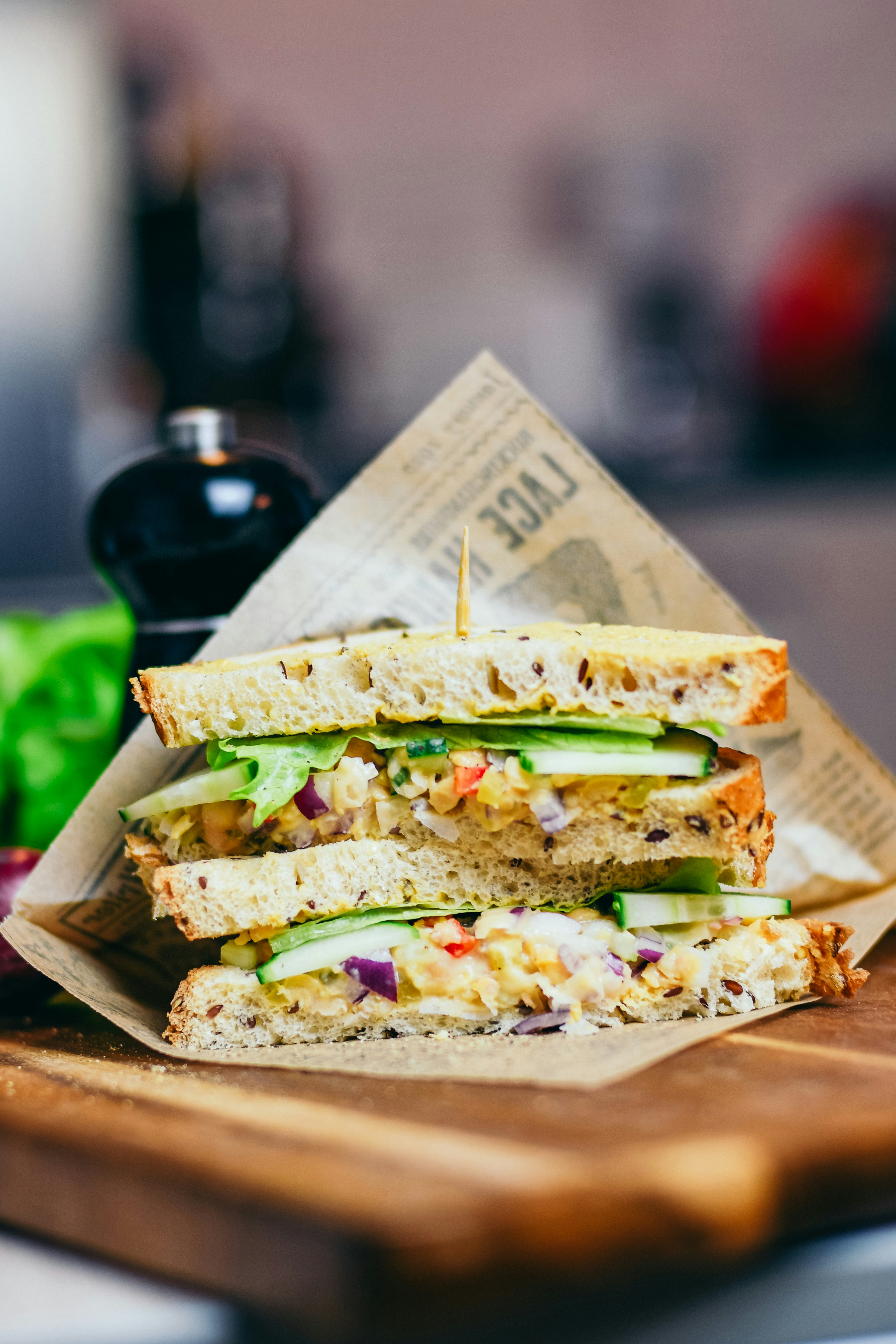A sandwich on a wooden board | Source: Unsplash