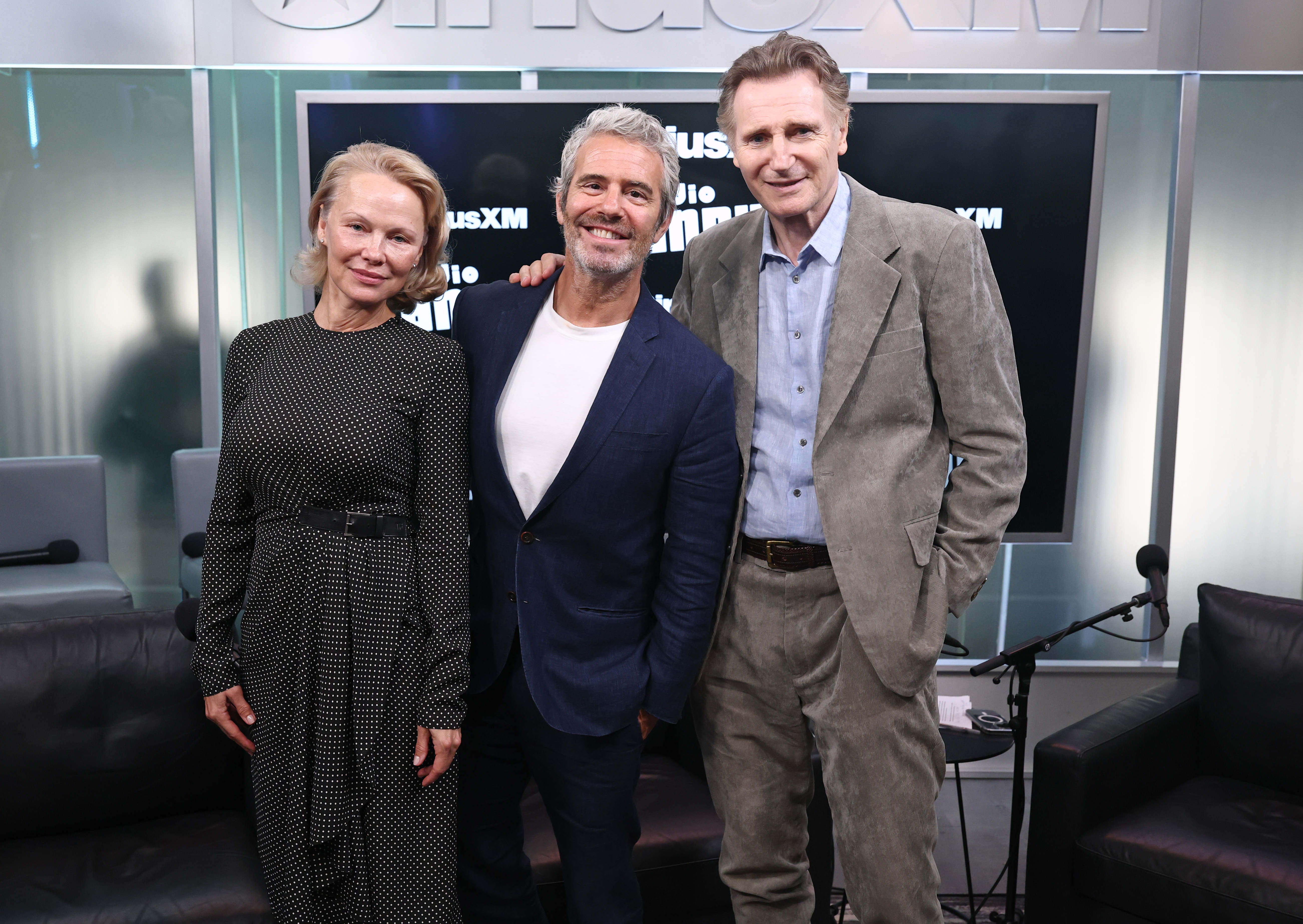 (L-R) Pamela Anderson, Andy Cohen, and Liam Neeson attend SiriusXM's Town Hall with the cast of "The Naked Gun," hosted by Andy Cohen at SiriusXM Studios on July 30, 2025, in New York City. | Source: Getty Images
