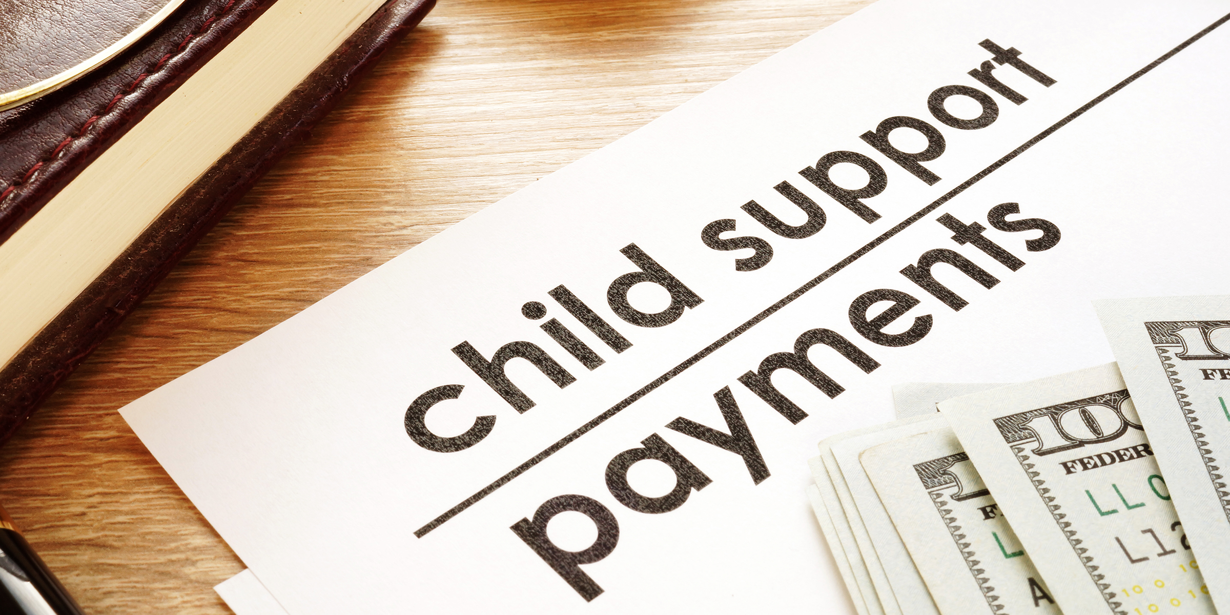 Cash and a document for child support payments | Source: Shutterstock
