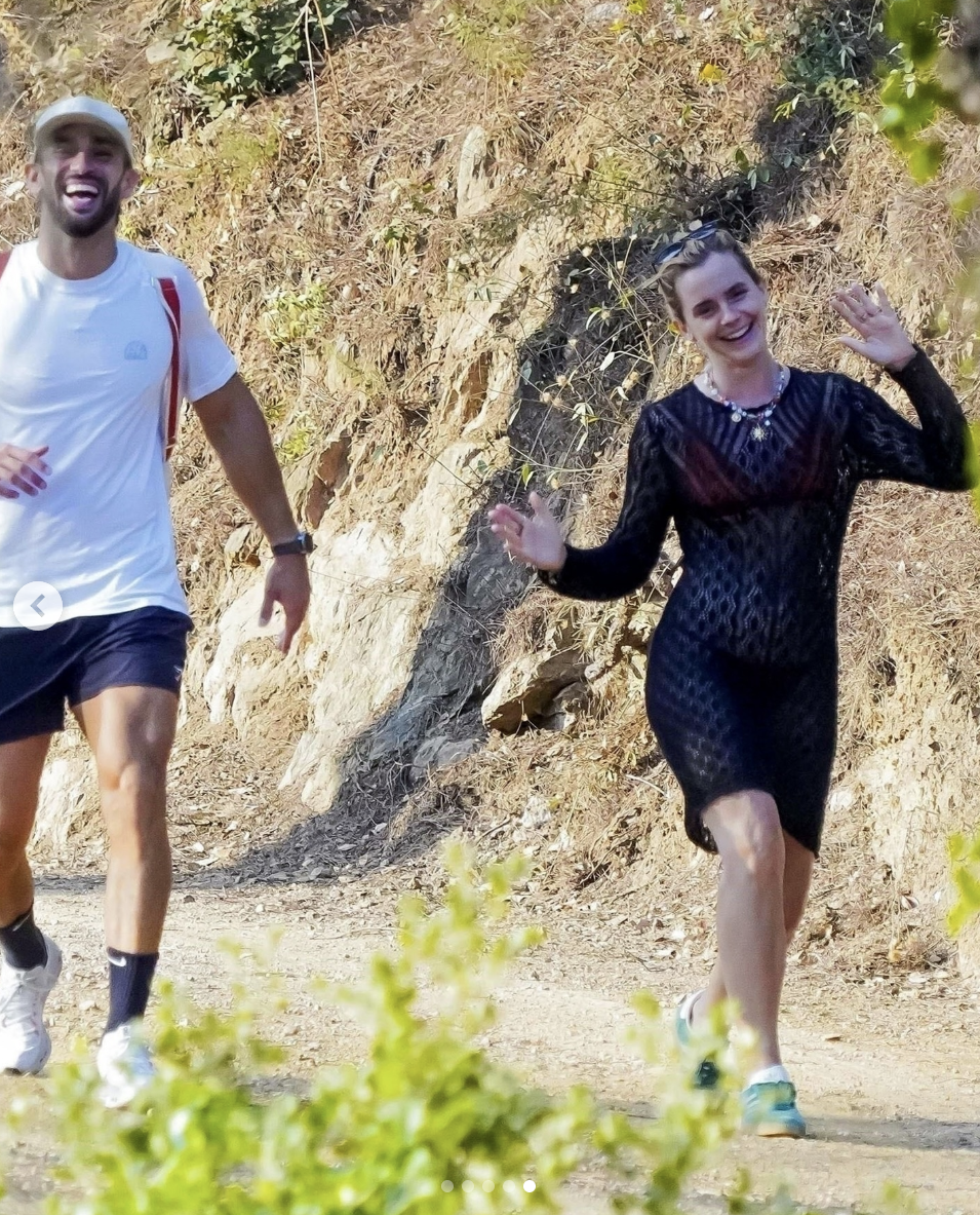 Emma Watson waves at the paparazzi while hiking with her personal trainer in Saint-Tropez, France. Posted on August 25, 2025. | Source: Instagram/deuxmoi