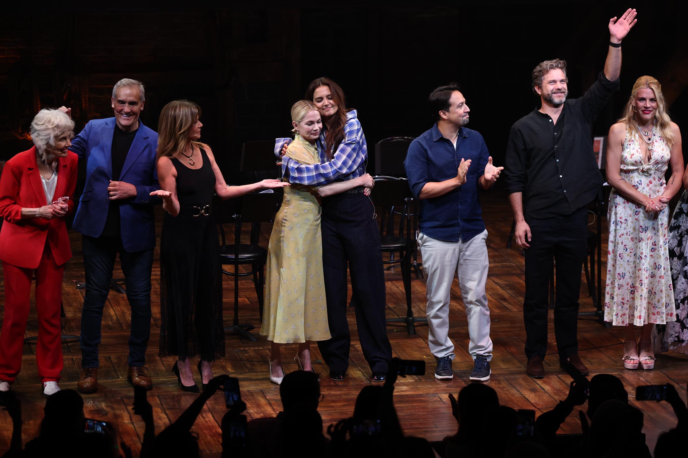 Michelle Williams and Katie Holmes embrace onstage as Mary Beth Peil, John Wesley Shipp, Mary Beth Peil, Lin-Manuel Miranda, Joshua Jackson and Busy Phillips attend the Dawson's Creek Class Reunion at Richard Rodgers Theatre on September 22, 2025, in New York City. | Source: Getty Images