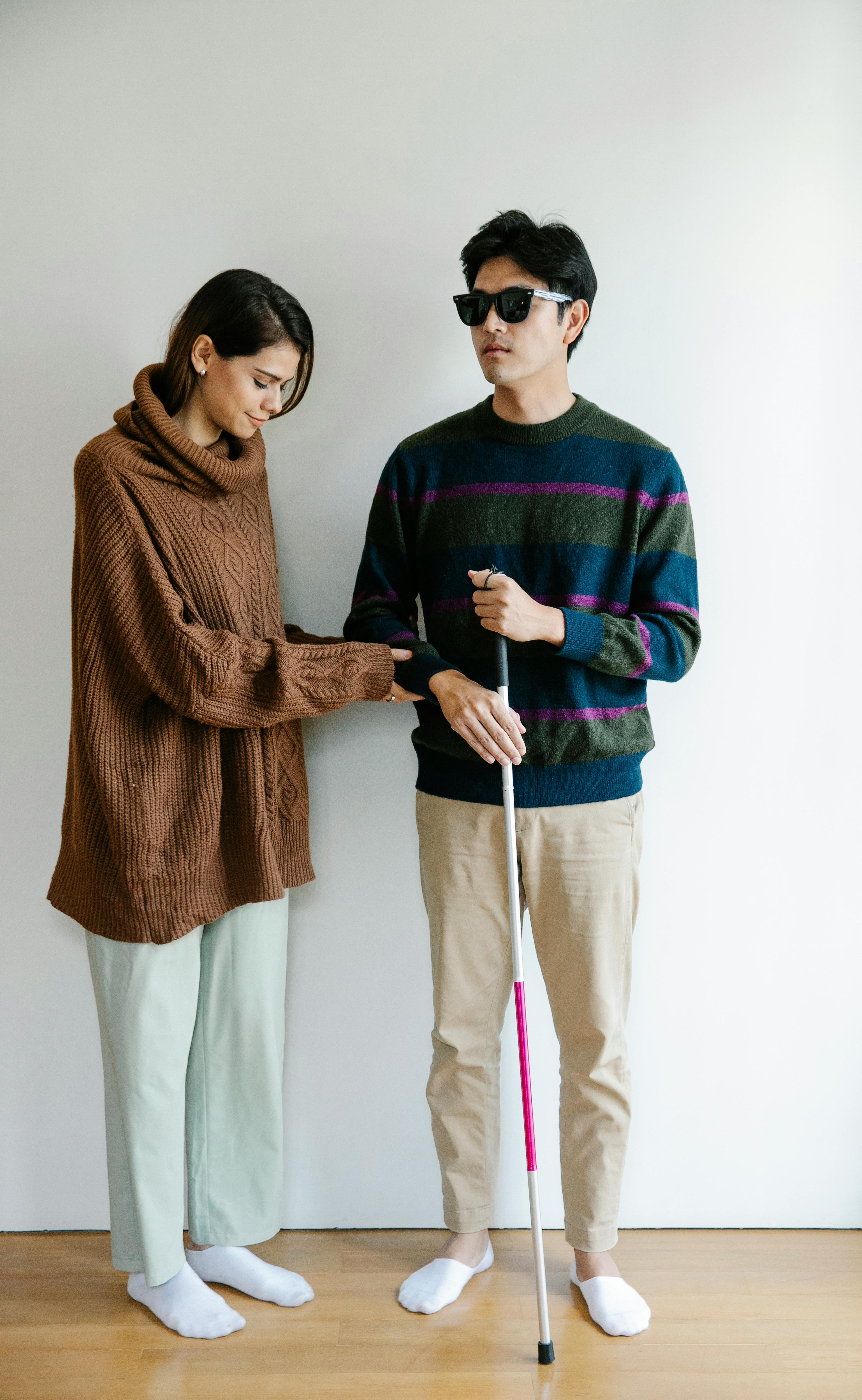 A woman guiding a man | Source: Pexels