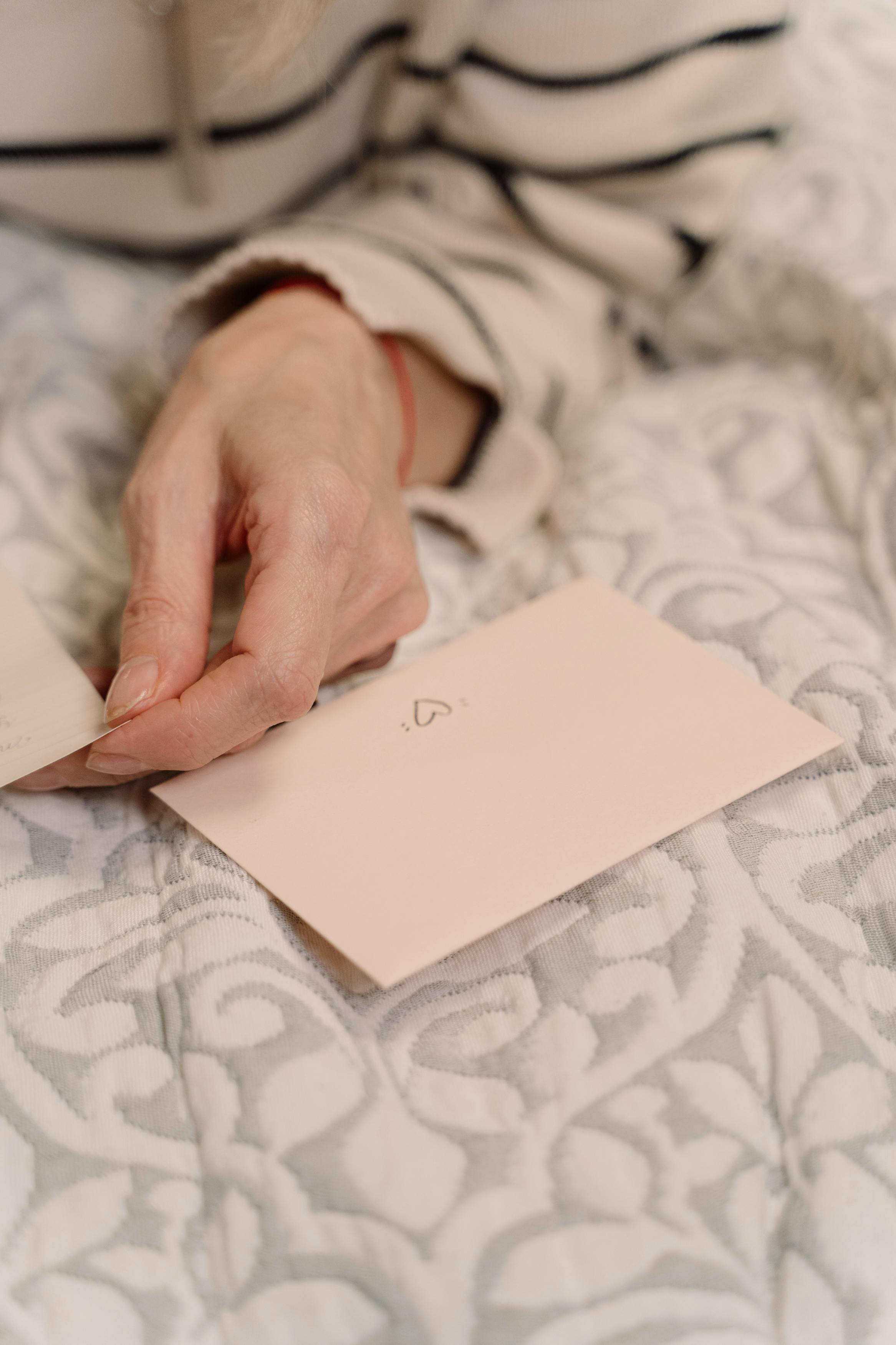 A folded note near a person's hand | Source: Pexels