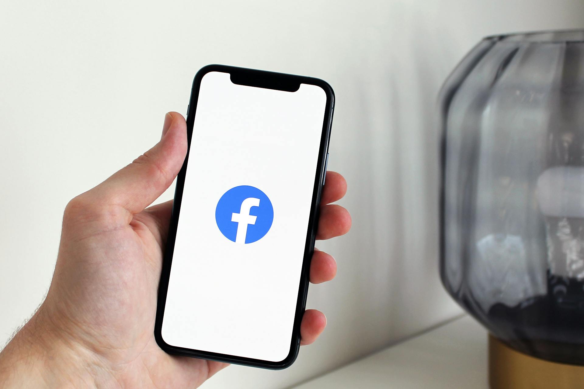 Facebook logo on a phone | Source: Pexels
