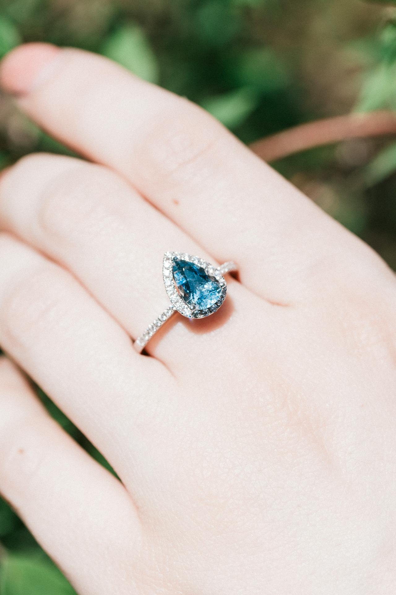 Close-up shot of a woman wearing a blue stone ring | Source: Pexels