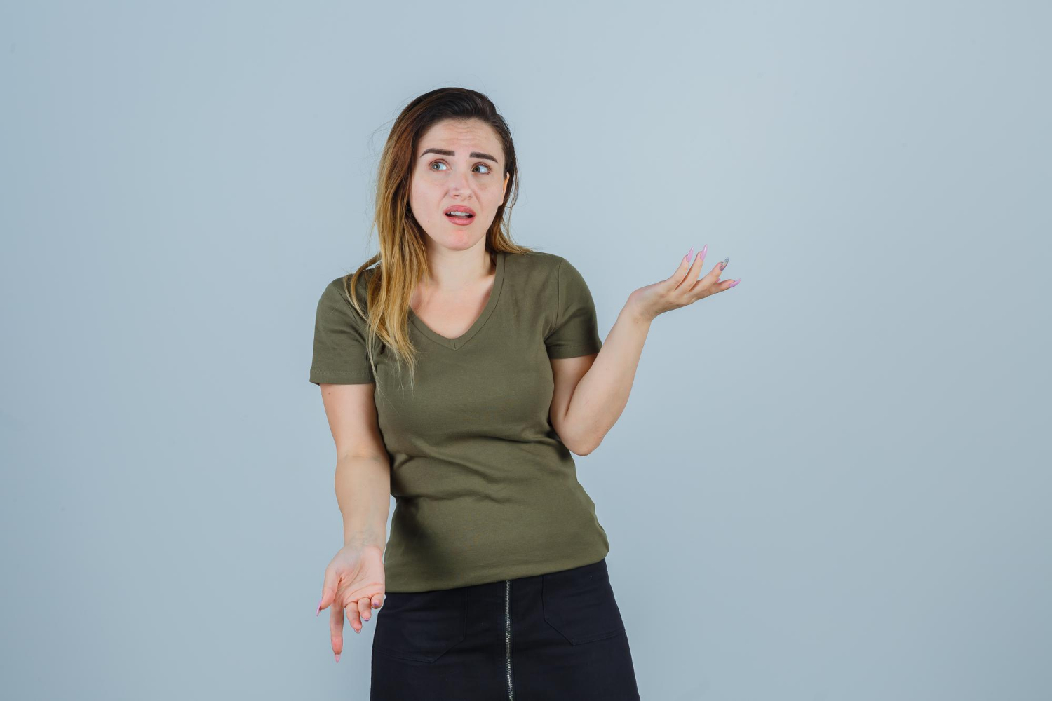 A woman gesturing indifferently | Source: Freepik