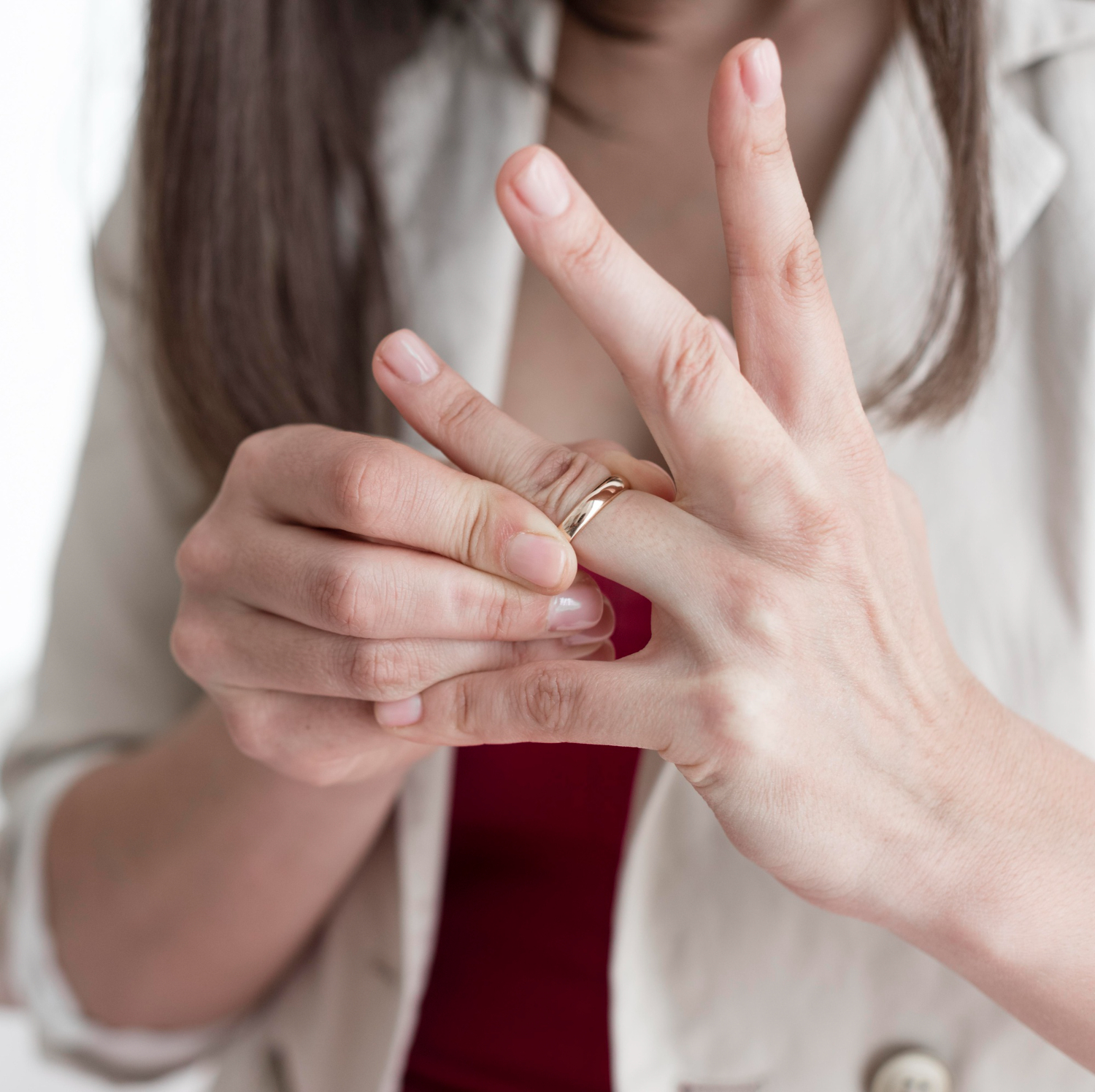 A woman taking off her wedding ring | Source: Freepik