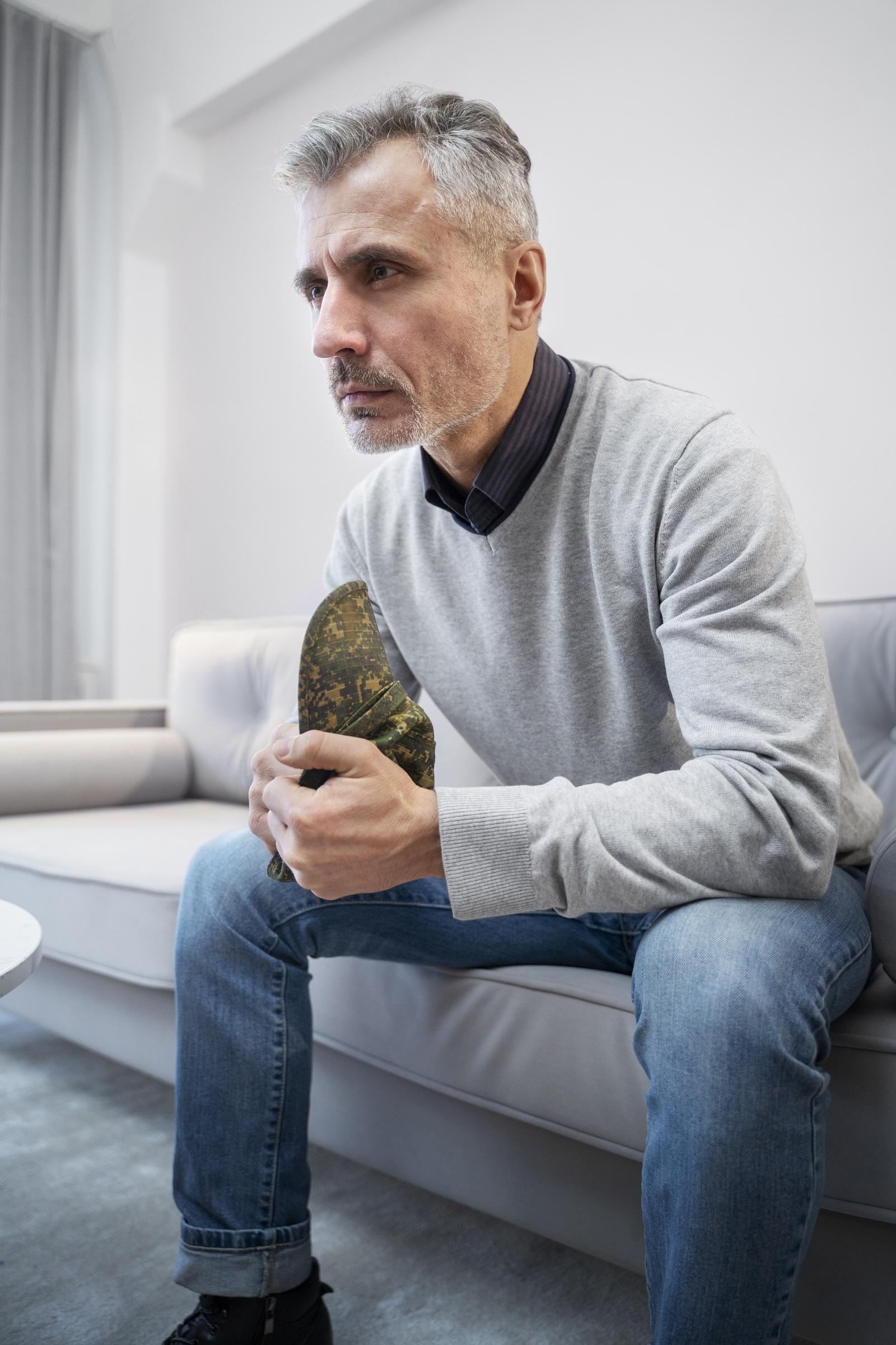 A distressed man sitting | Source: Freepik