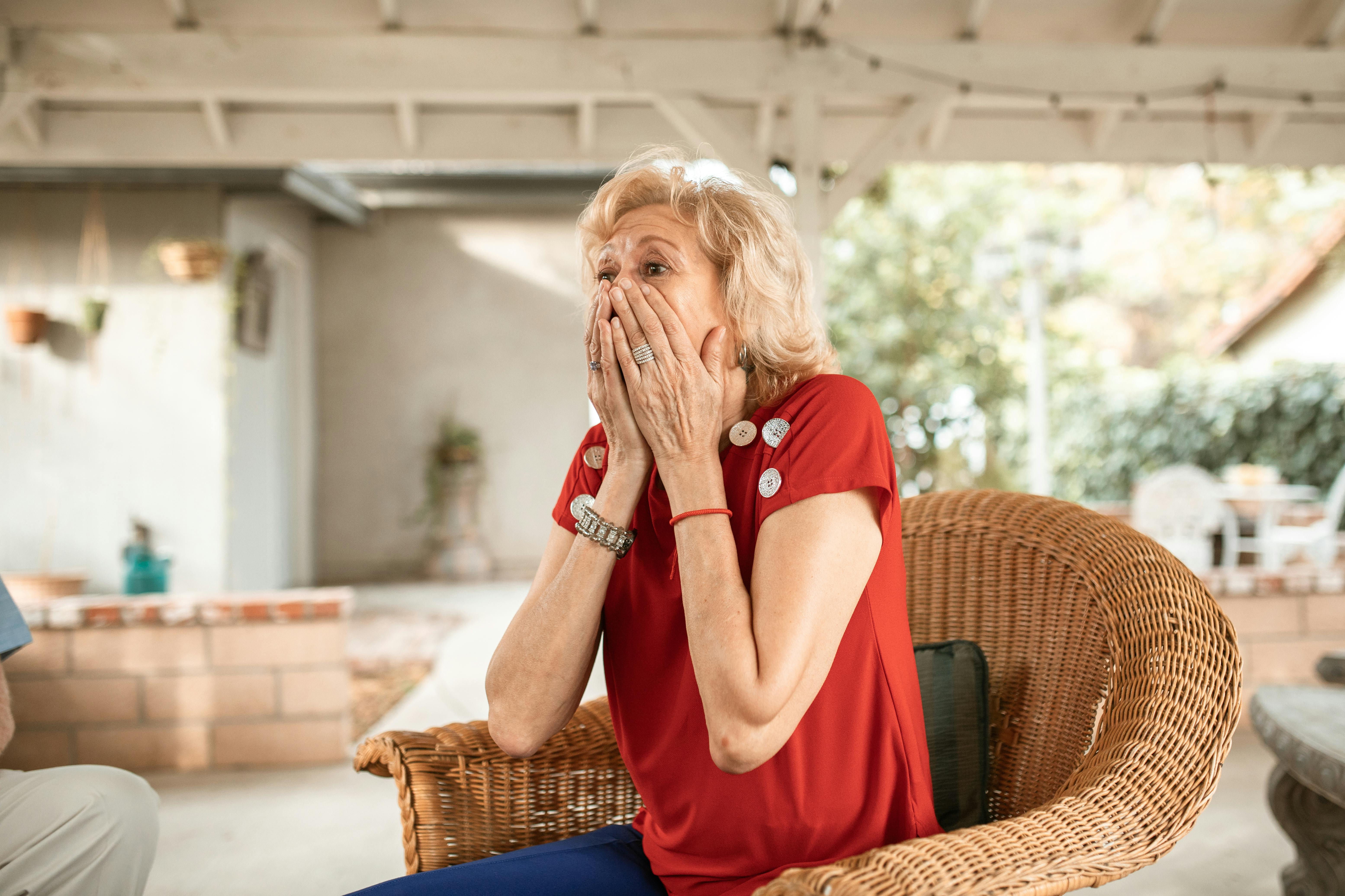 A shocked woman getting up from her seat | Source: Pexels