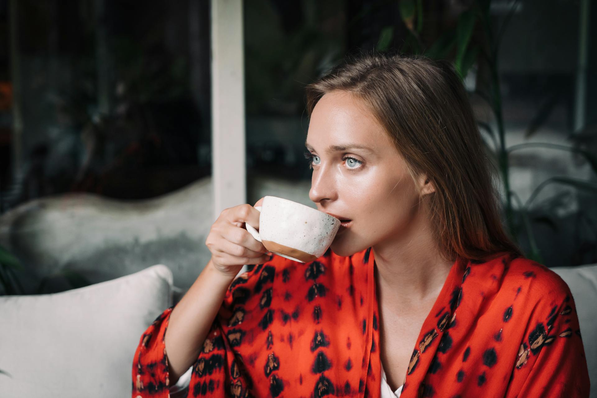 A woman drinking tea staring at someone | Source: Pexels