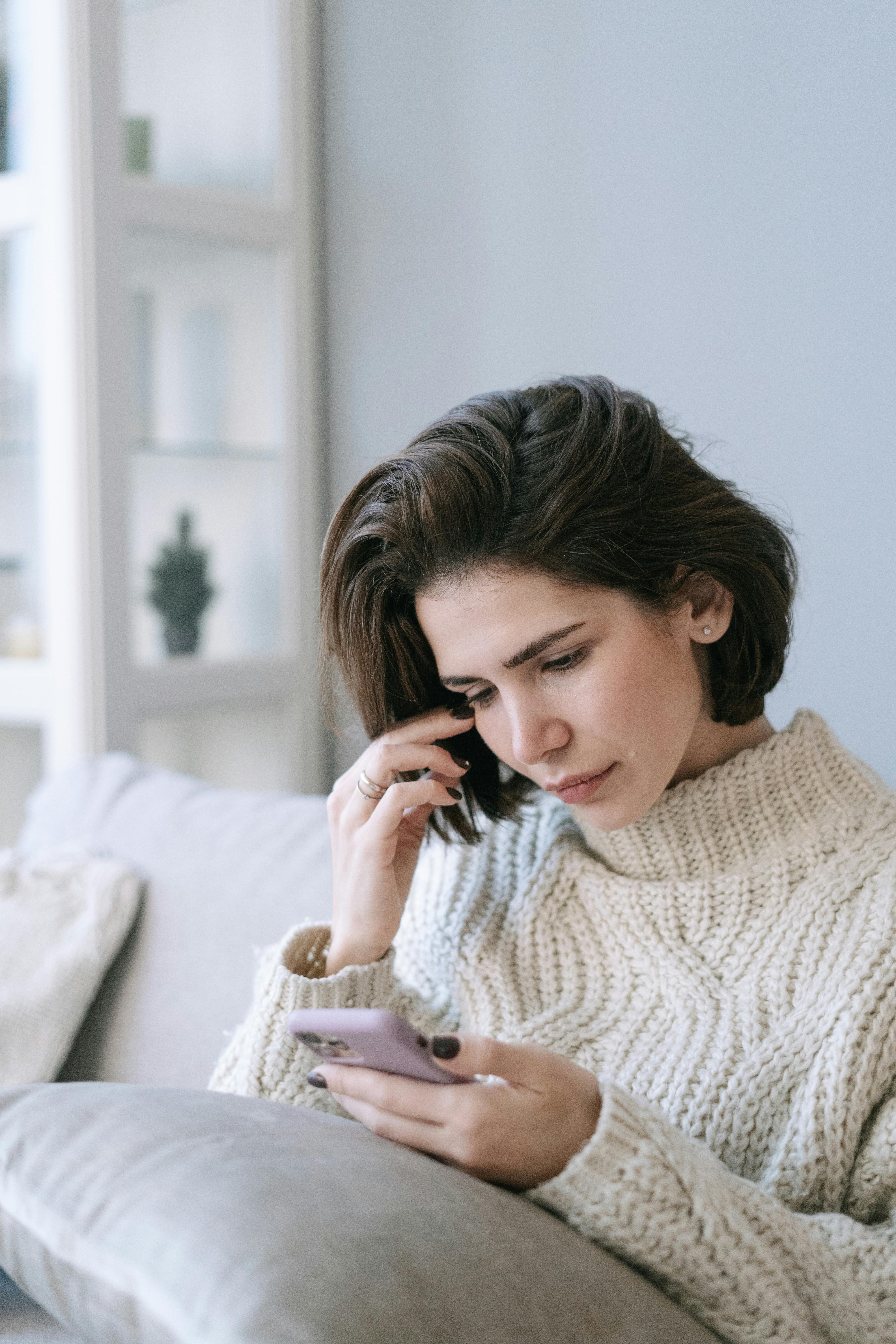 A woman looking at her cellphone | Source: Pexels