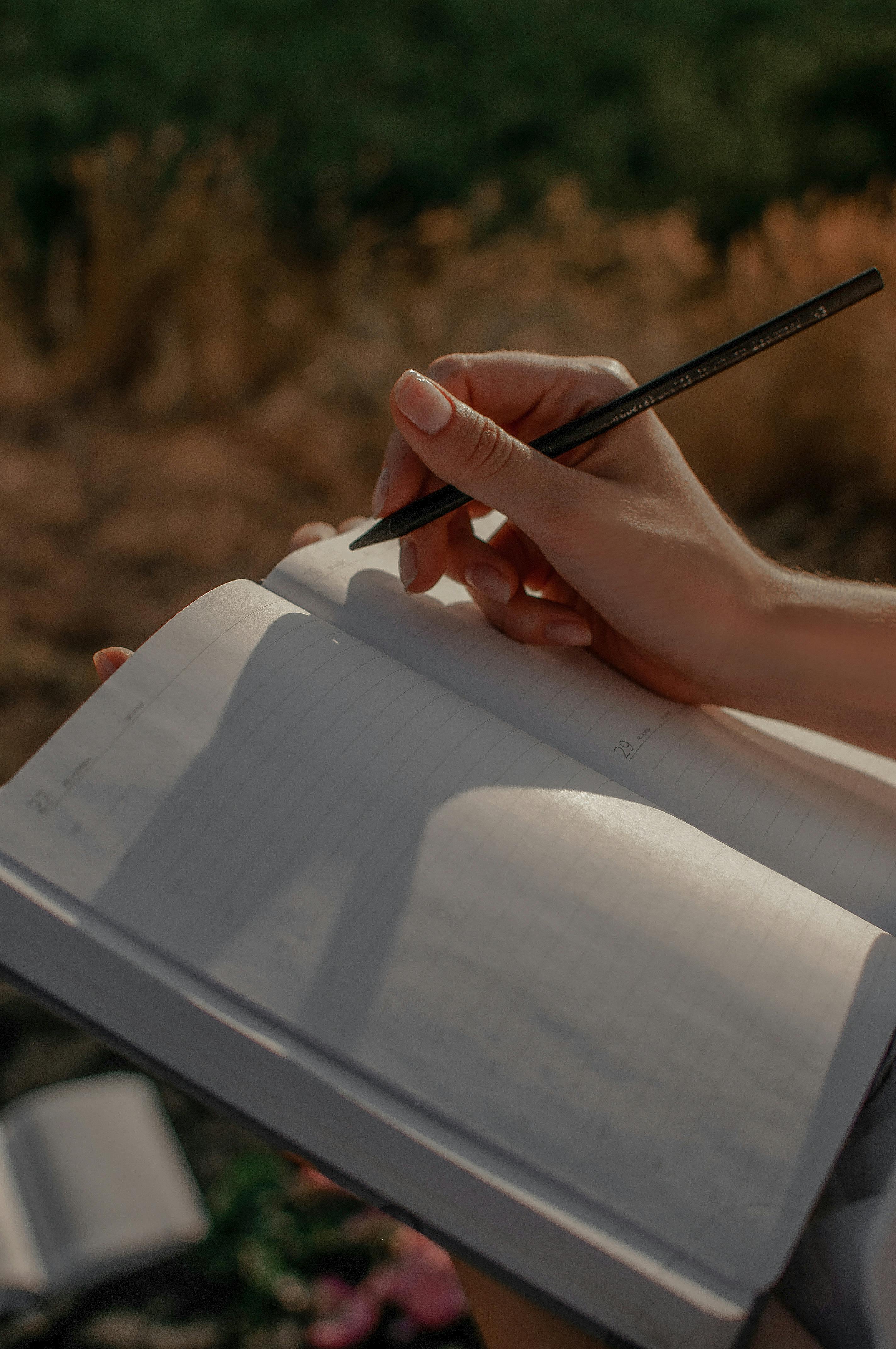 A woman writing in a journal | Source: Pexels