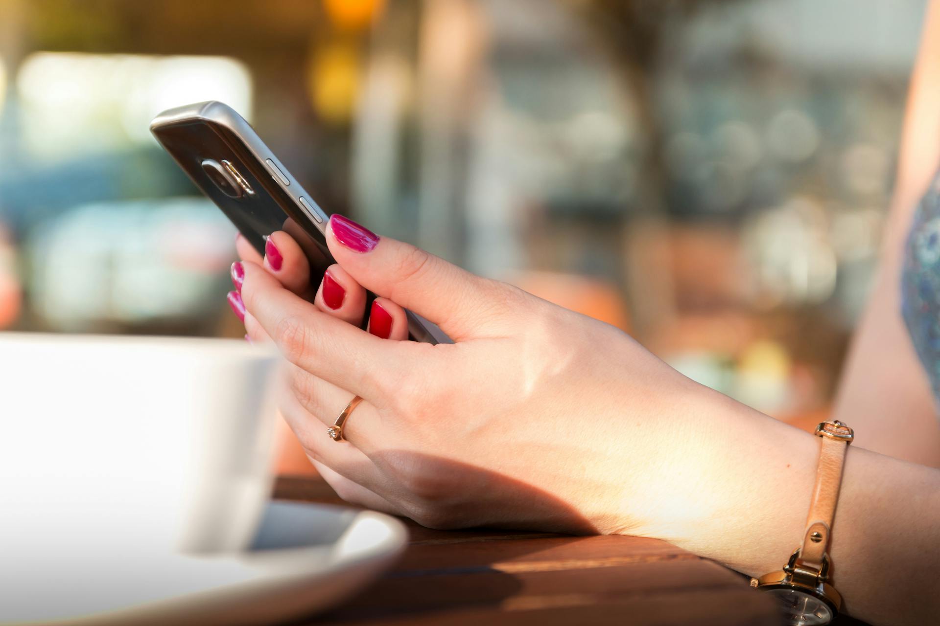 A woman holding her phone | Source: Pexels