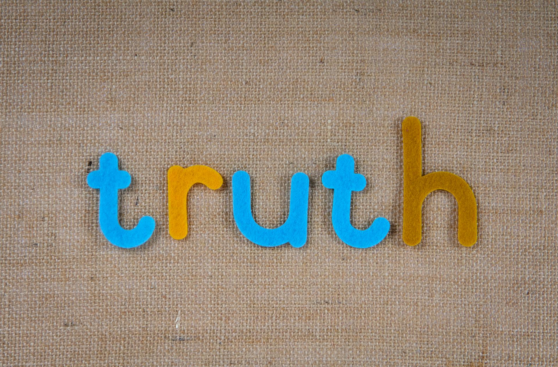 A cutout of letters on a brown surface | Source: Pexels