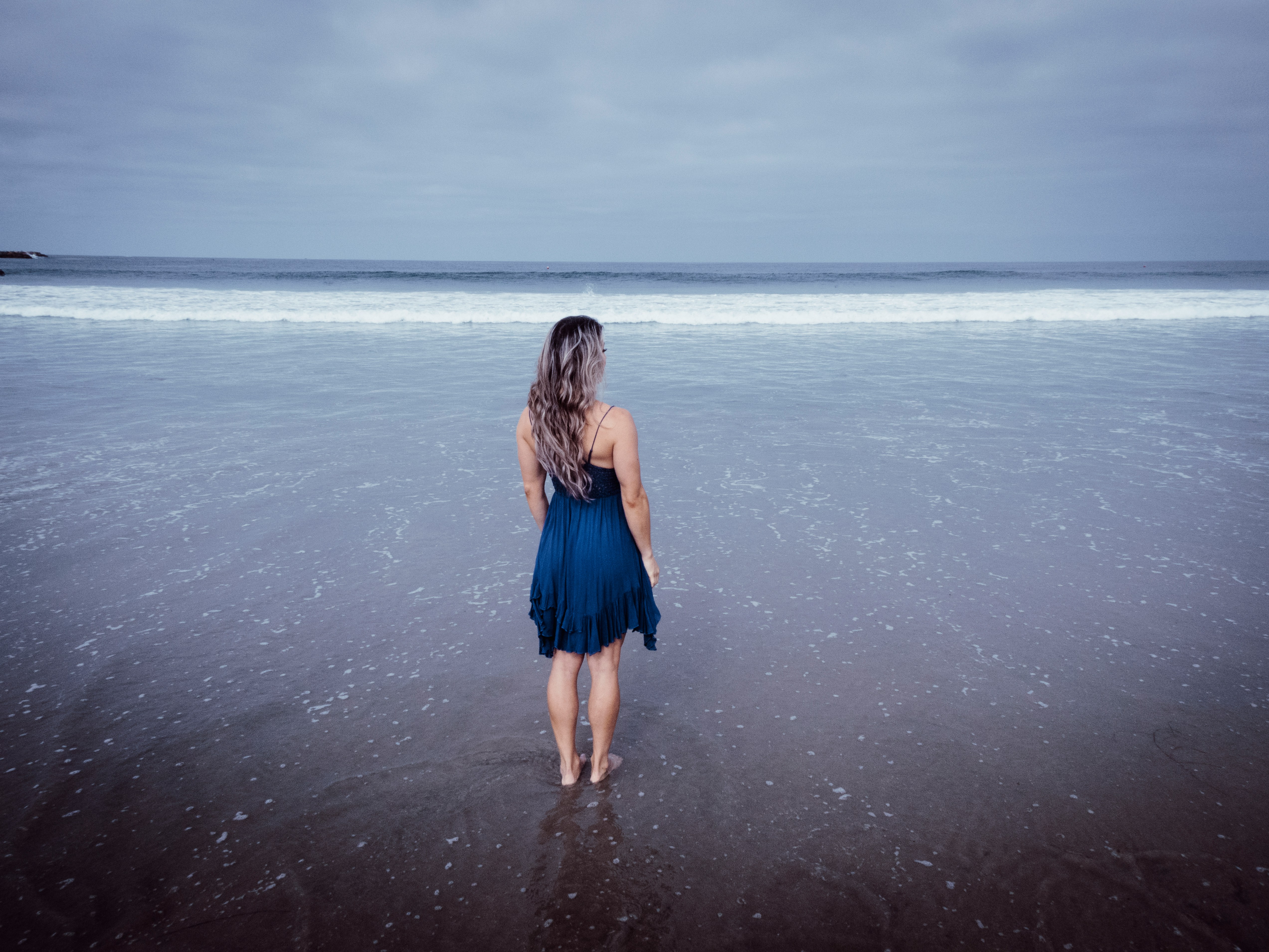 A woman standing at a beach | Source: Unsplash