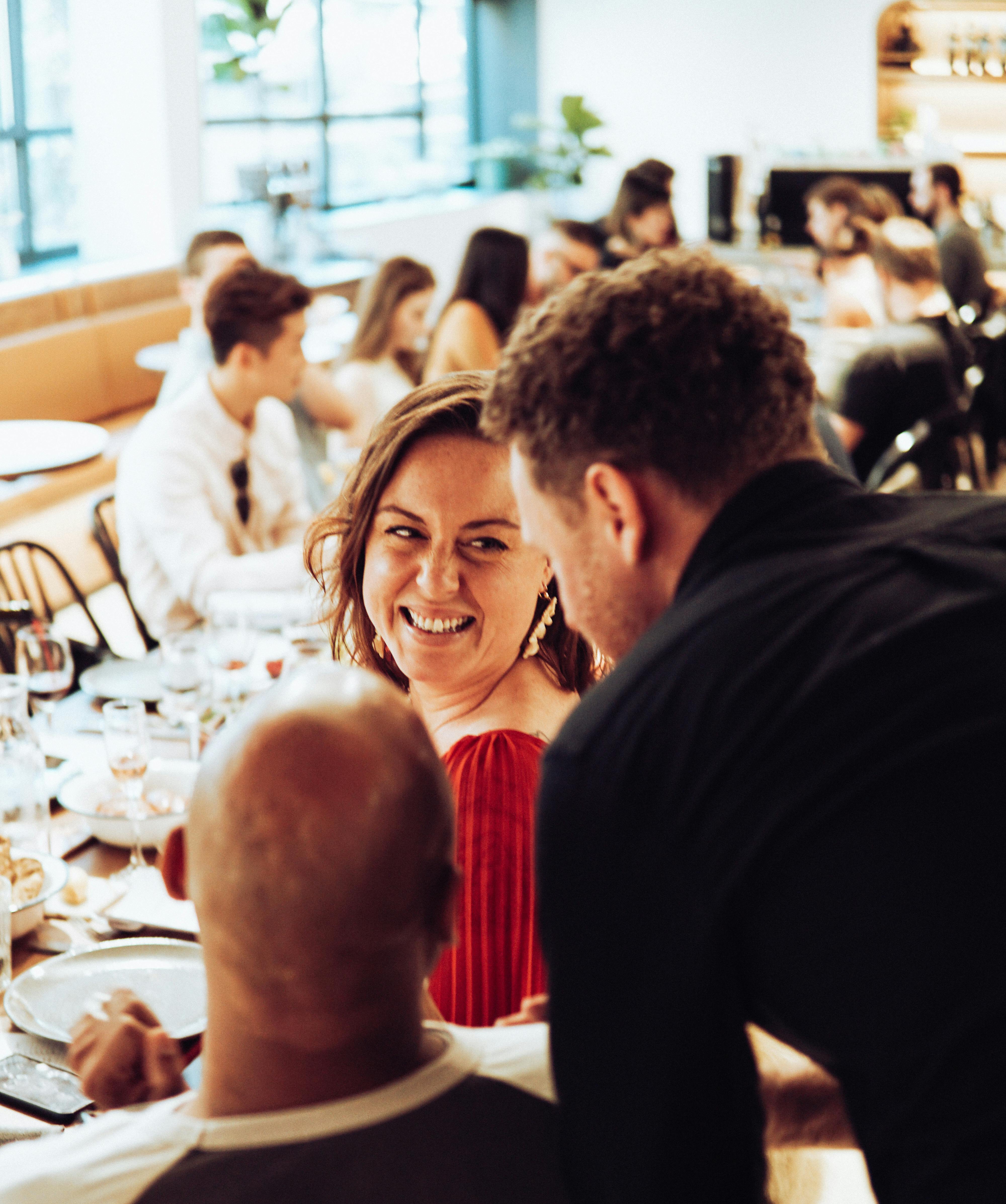 A man standing behind a sitting couple | Source: Pexels