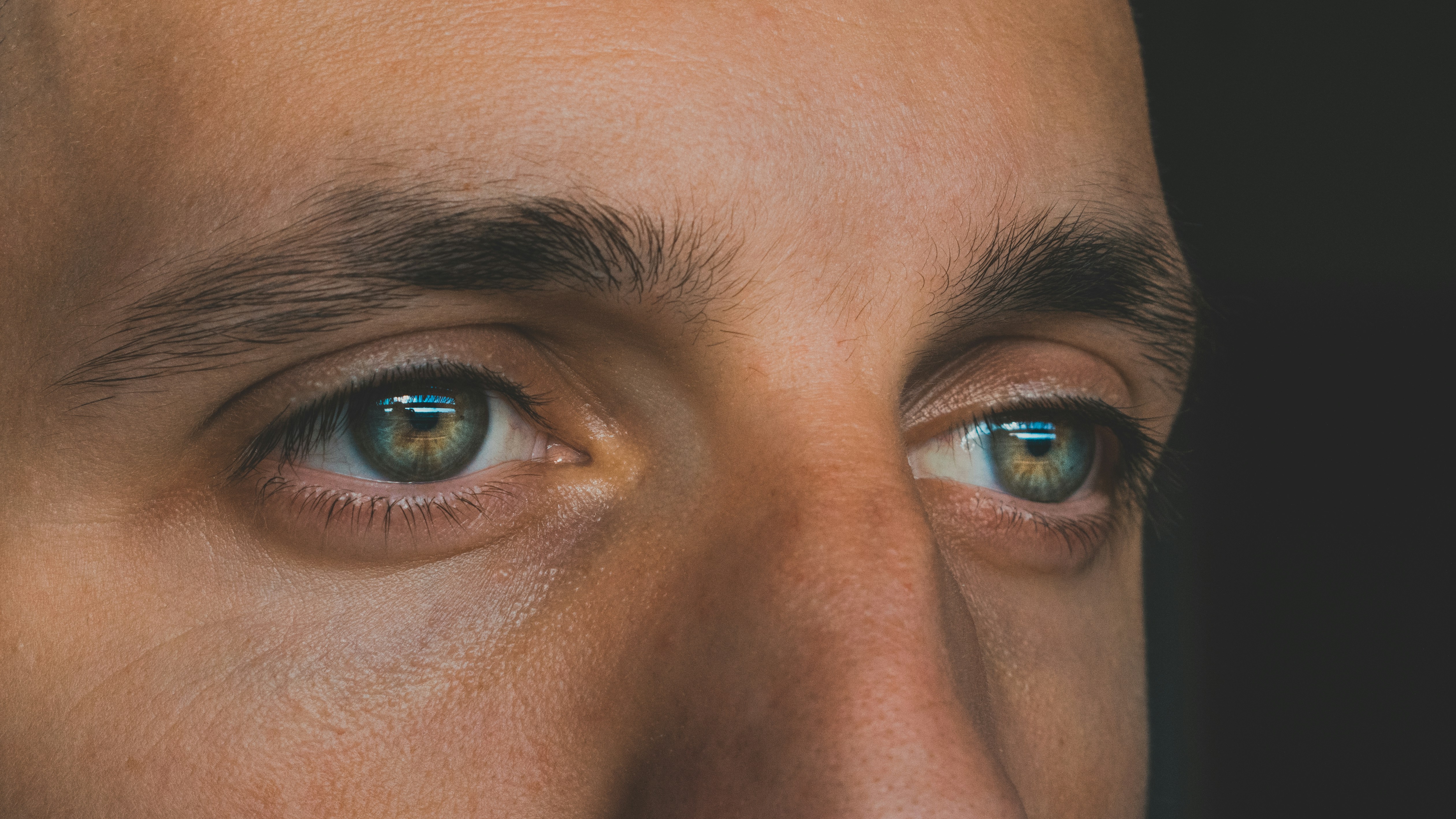 A close-up of a sad man's eyes | Source: Unsplash
