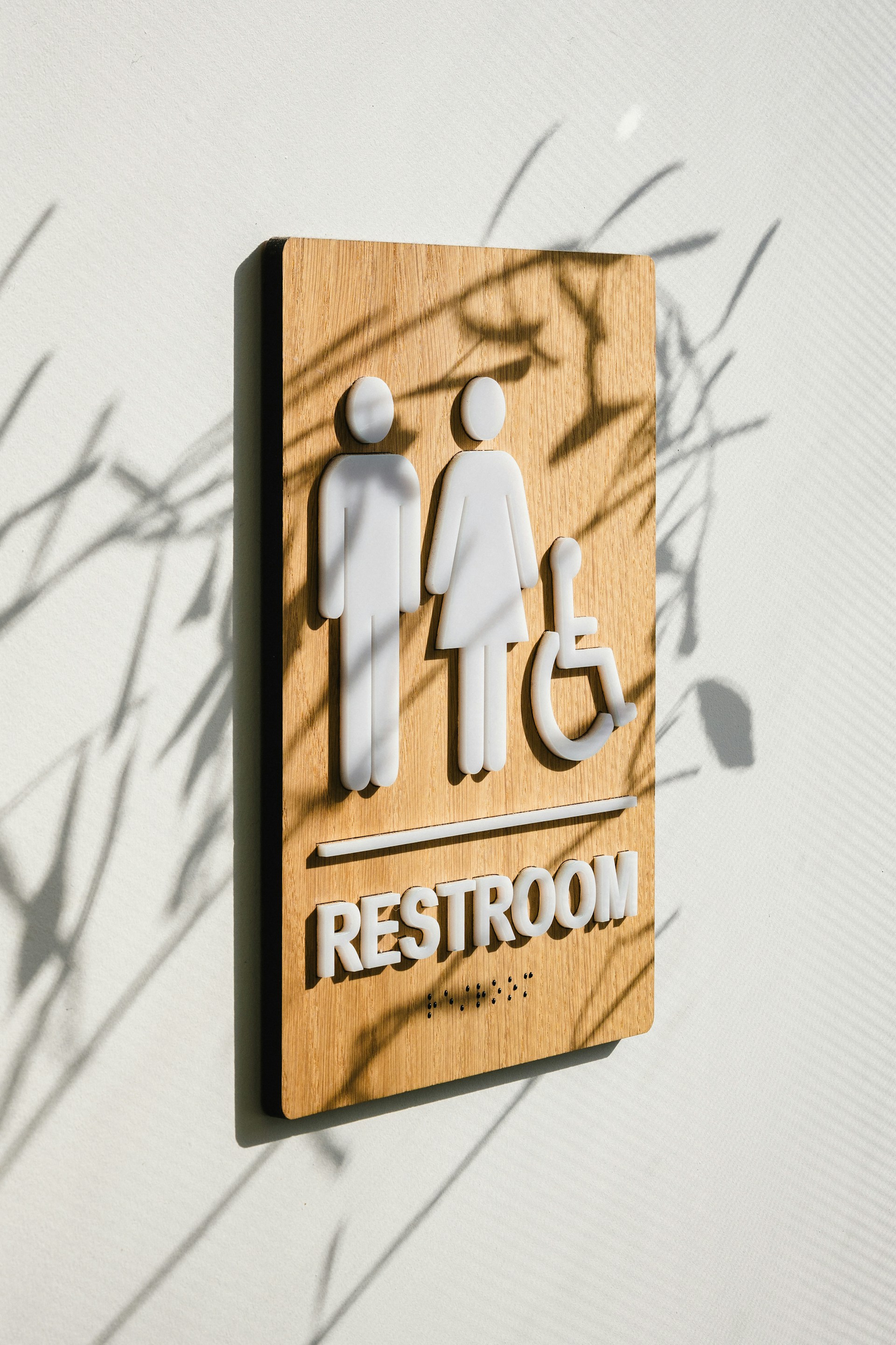 A restroom sign on the wall | Source: Unsplash