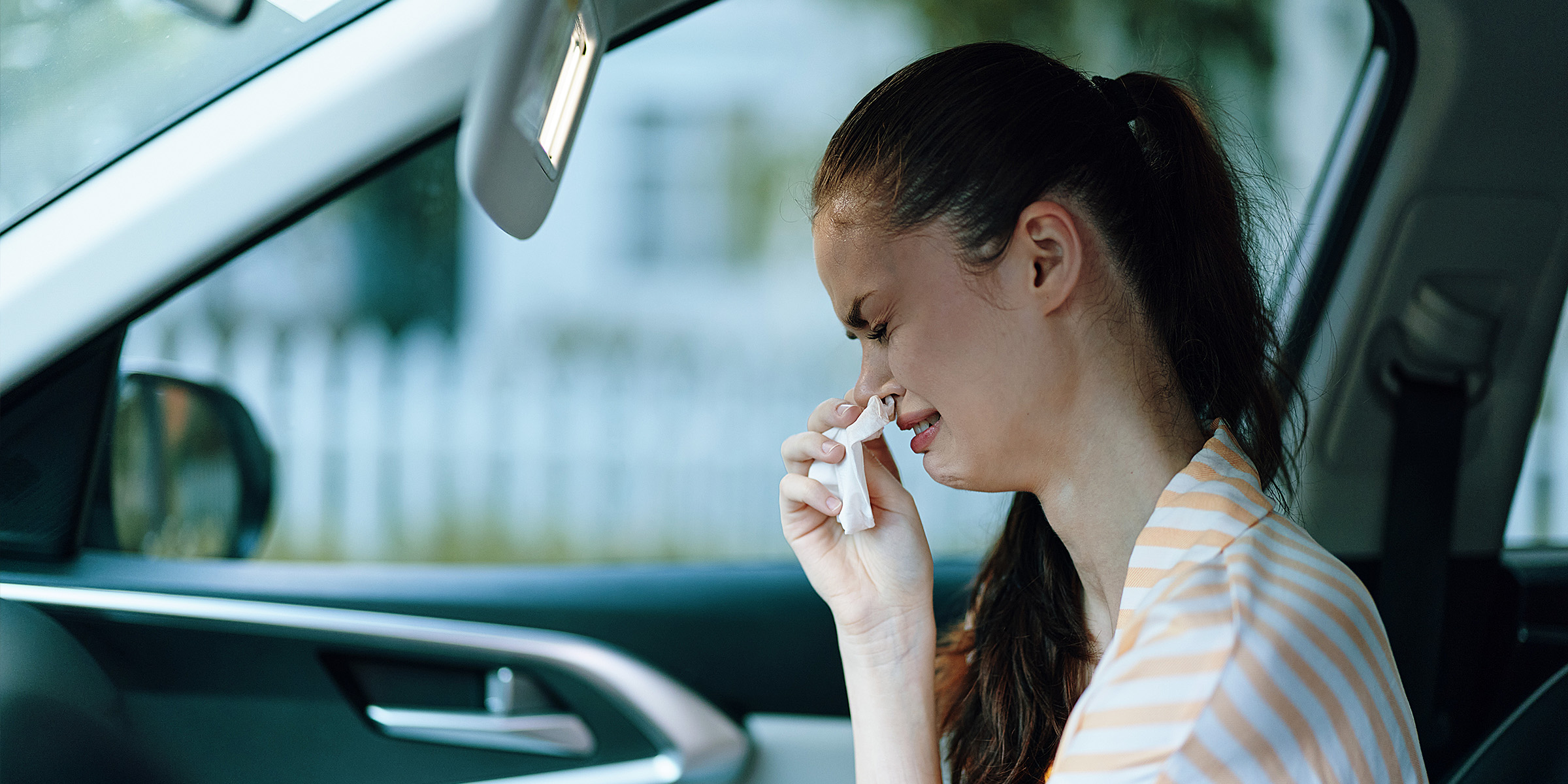 A woman crying in a car | Source: Shutterstock