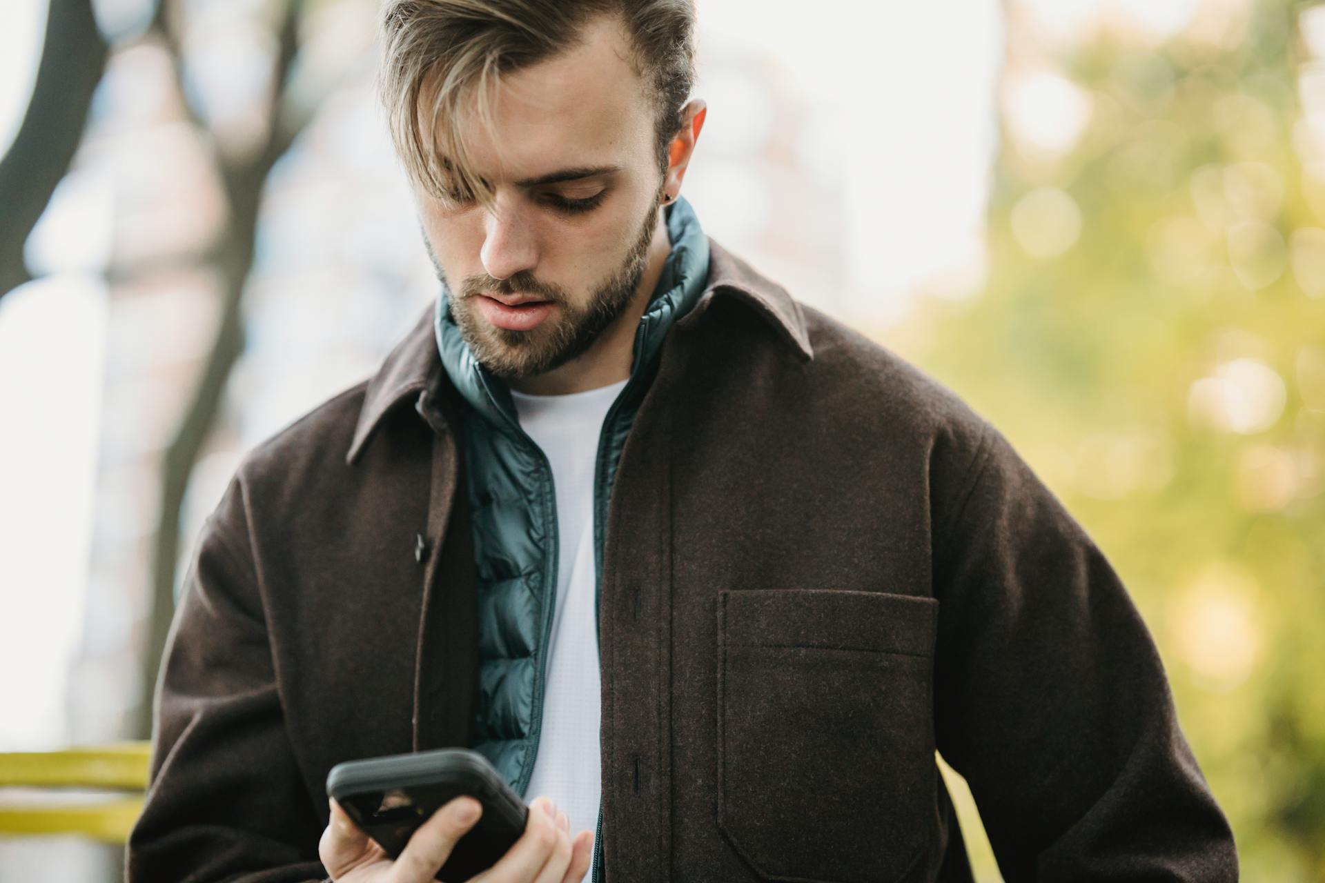 A man staring down at his phone | Source: Pexels